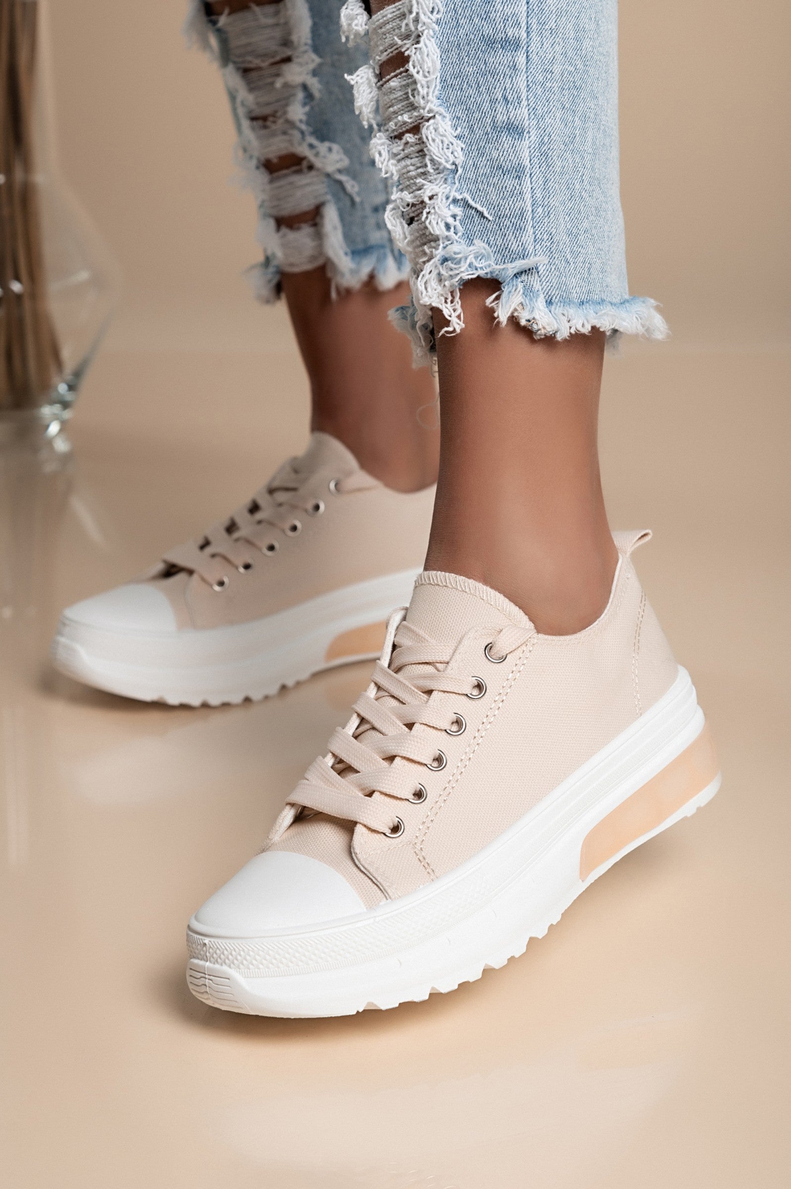 Beige fashion sneakers with raised sole, round toe, and lace-up design, made from high-quality fabric for comfort.