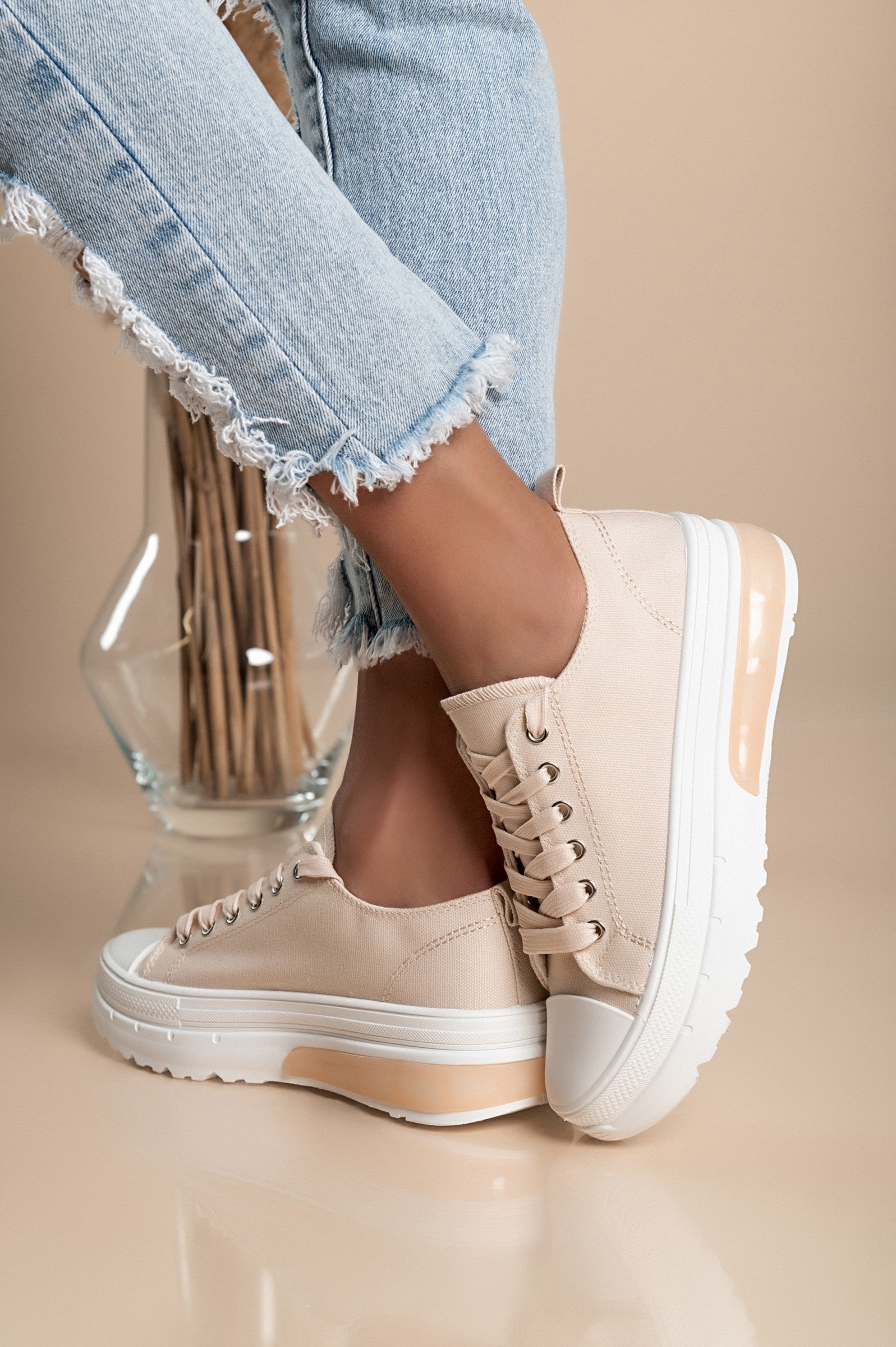 Beige fashion sneakers with raised sole, round toe, and lace-up design, made from high-quality fabric for comfort.