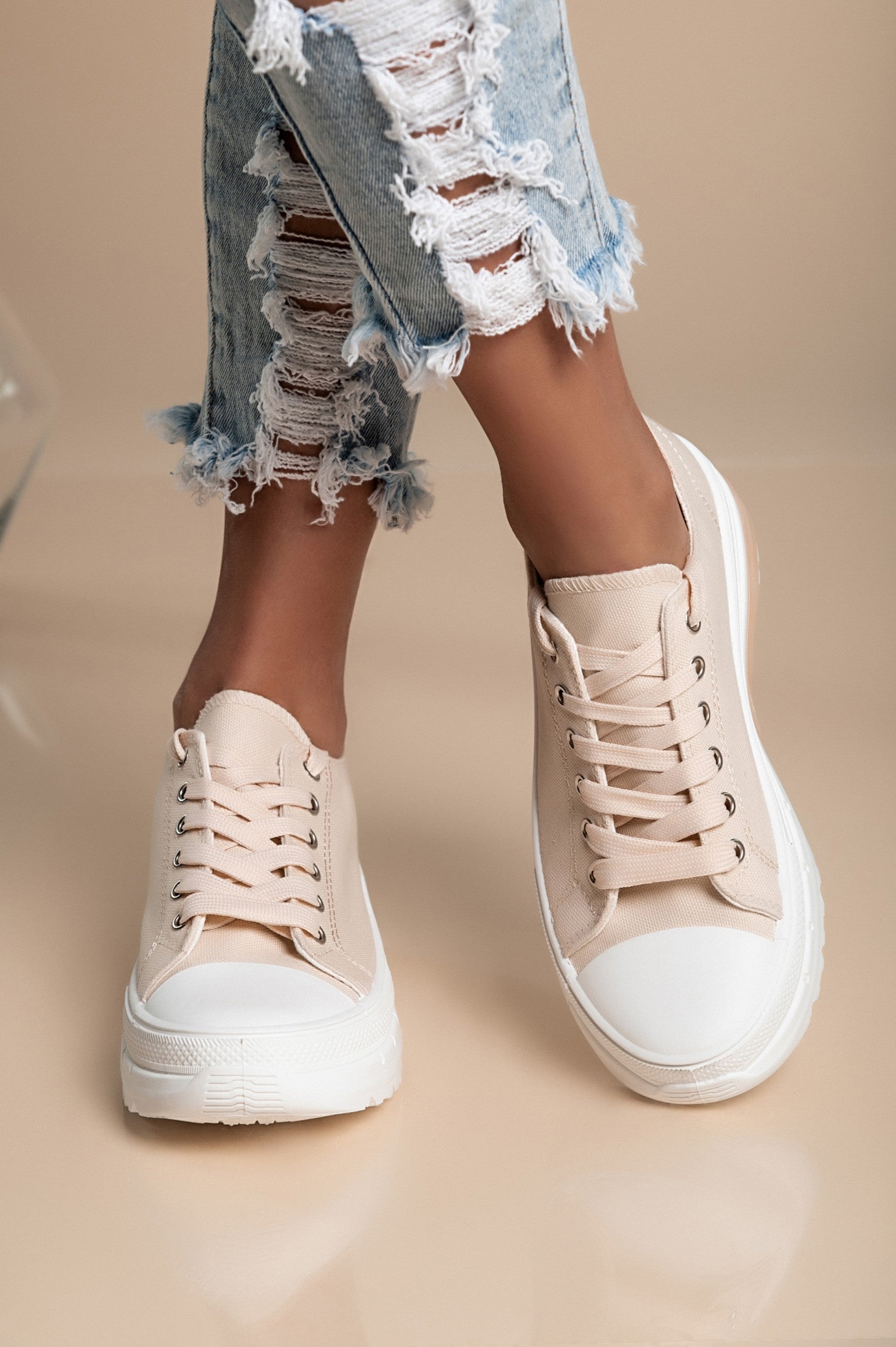 Beige fashion sneakers with raised sole, round toe, and lace-up design, made from high-quality fabric for comfort.