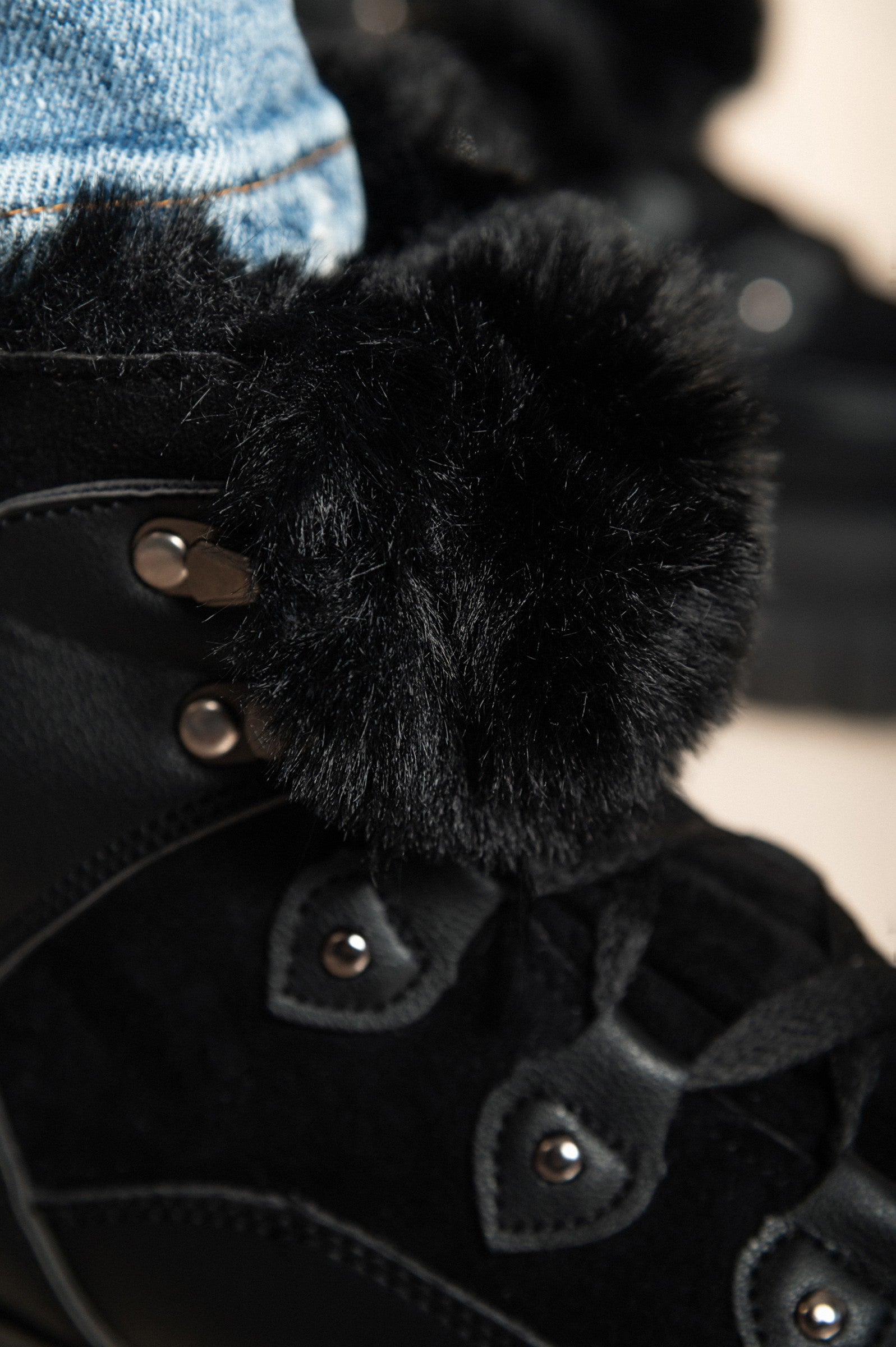 Close-up of black fur boot.