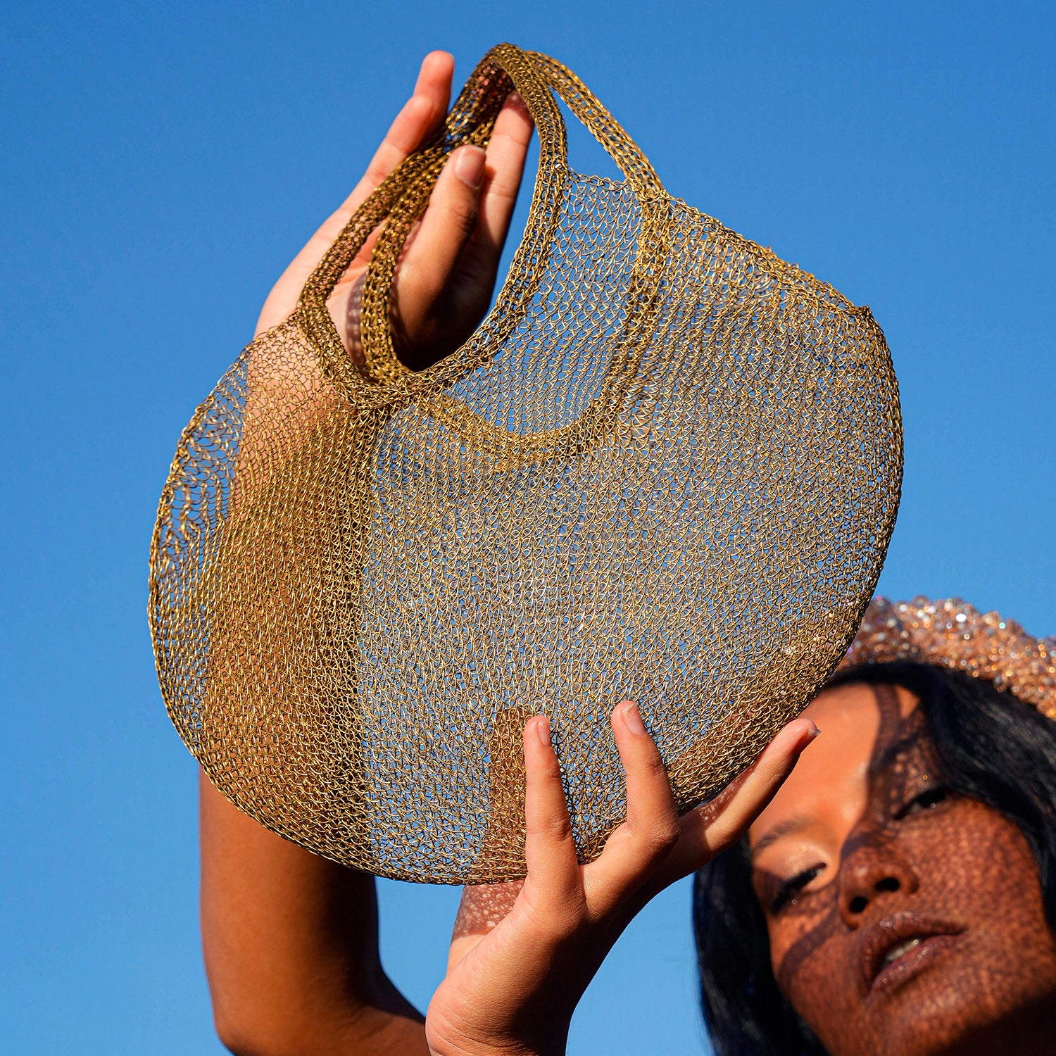 SOL Mesh Wire Tote Bag in Dark Gold, handwoven from stainless metal wire, showcasing its unique design and craftsmanship.