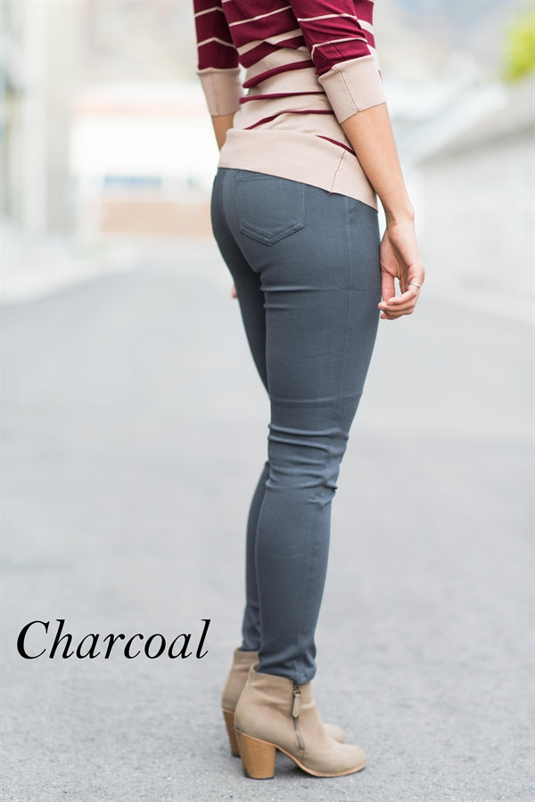 A pair of Solid Butt Lift Pull On Skinny Pants in a sleek design, showcasing a high-waist and tapered hem, made from stretchy fabric.