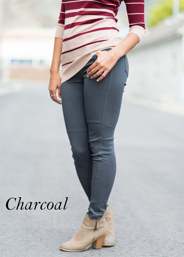 A pair of Solid Butt Lift Pull On Skinny Pants in a sleek design, showcasing a high-waist and tapered hem, made from stretchy fabric.