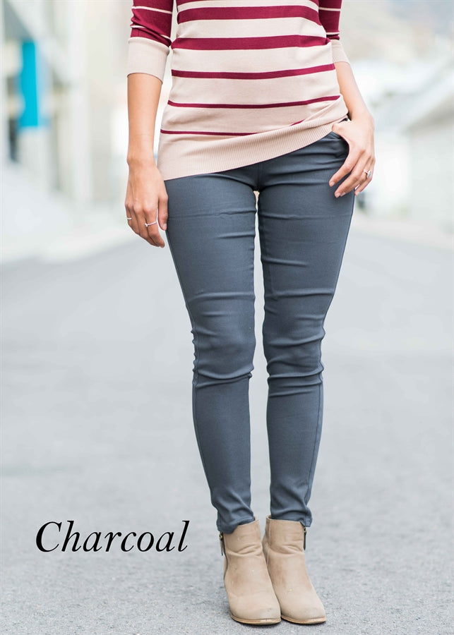 A pair of Solid Butt Lift Pull On Skinny Pants in a sleek design, showcasing a high-waist and tapered hem, made from stretchy fabric.