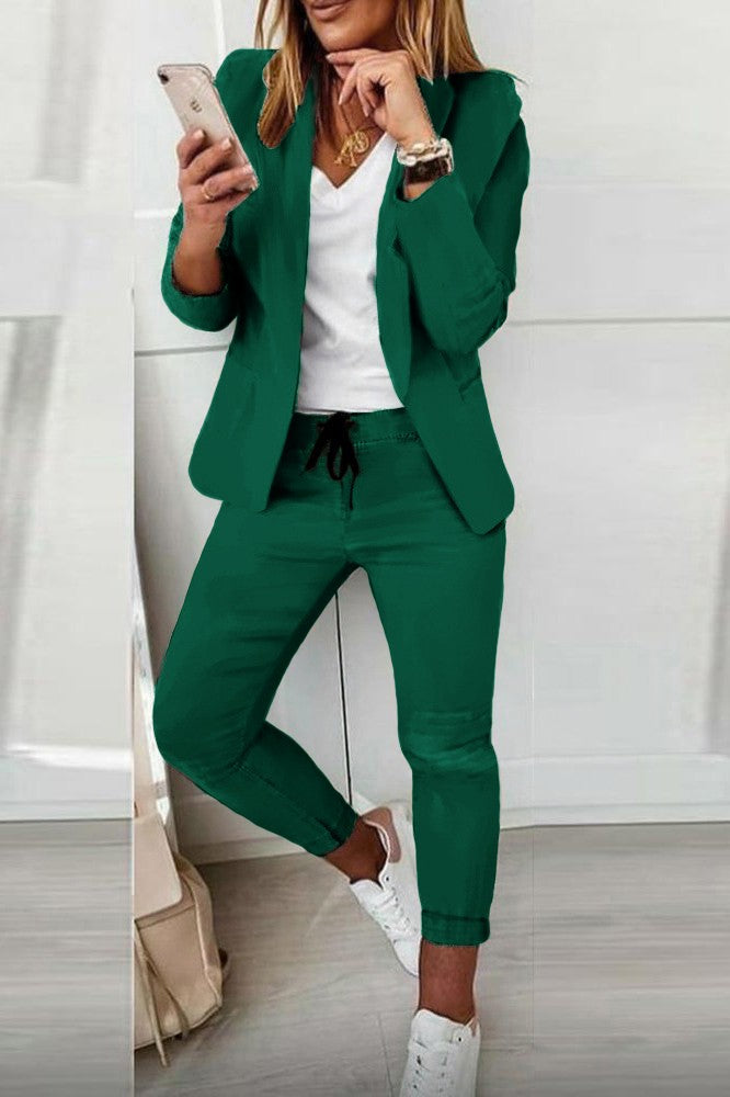 Light green elegant blazer and trousers set, showcasing a classic collar and long sleeves, perfect for stylish occasions.