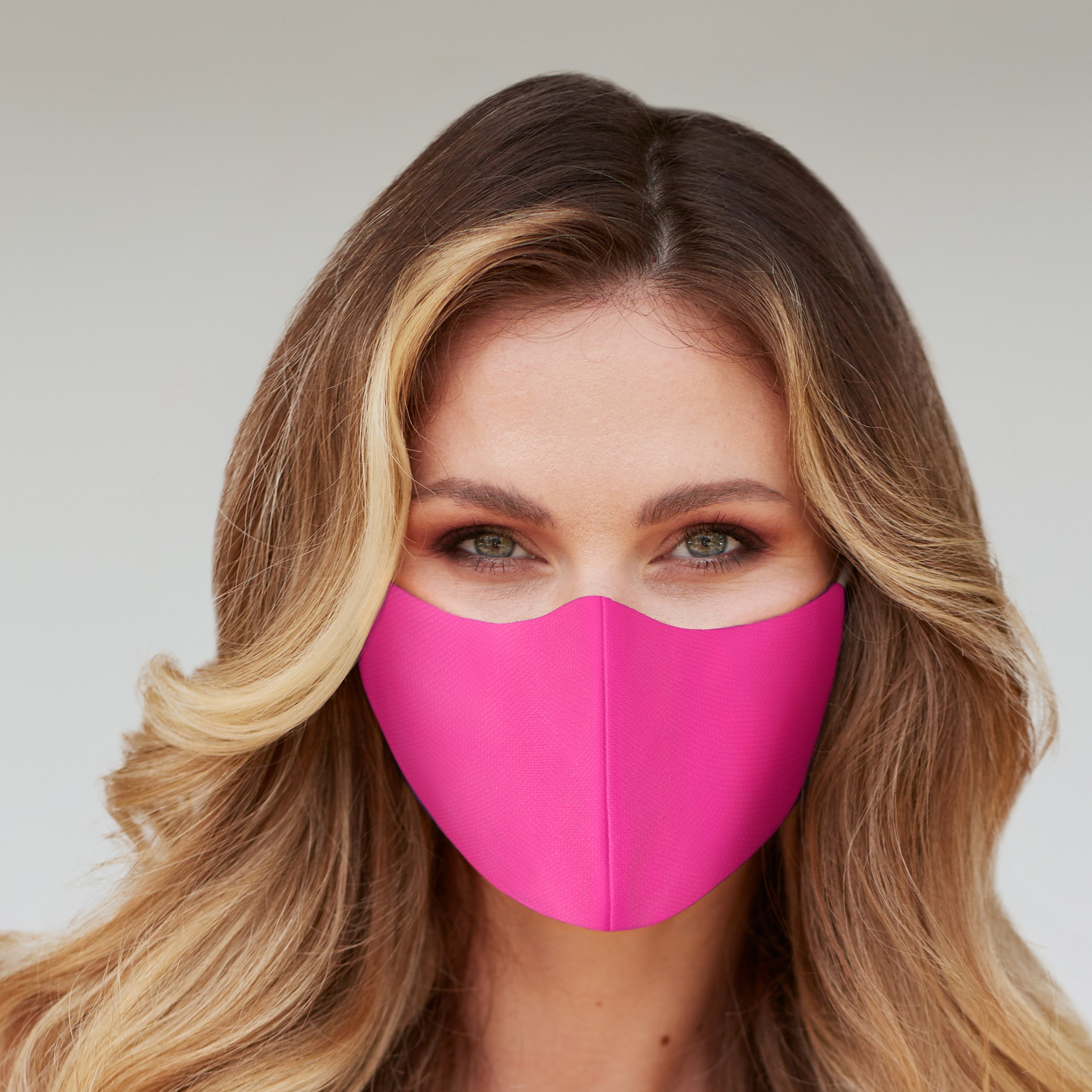 Solid Neon Pink Face Mask displayed on a white background, showcasing its vibrant color and fabric texture.