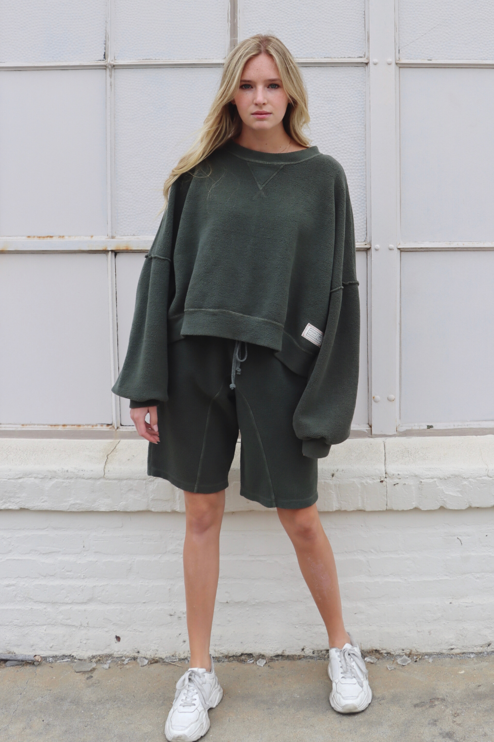 Sophie Shorts in Olive color with pockets and drawstring waist, displayed on a model.