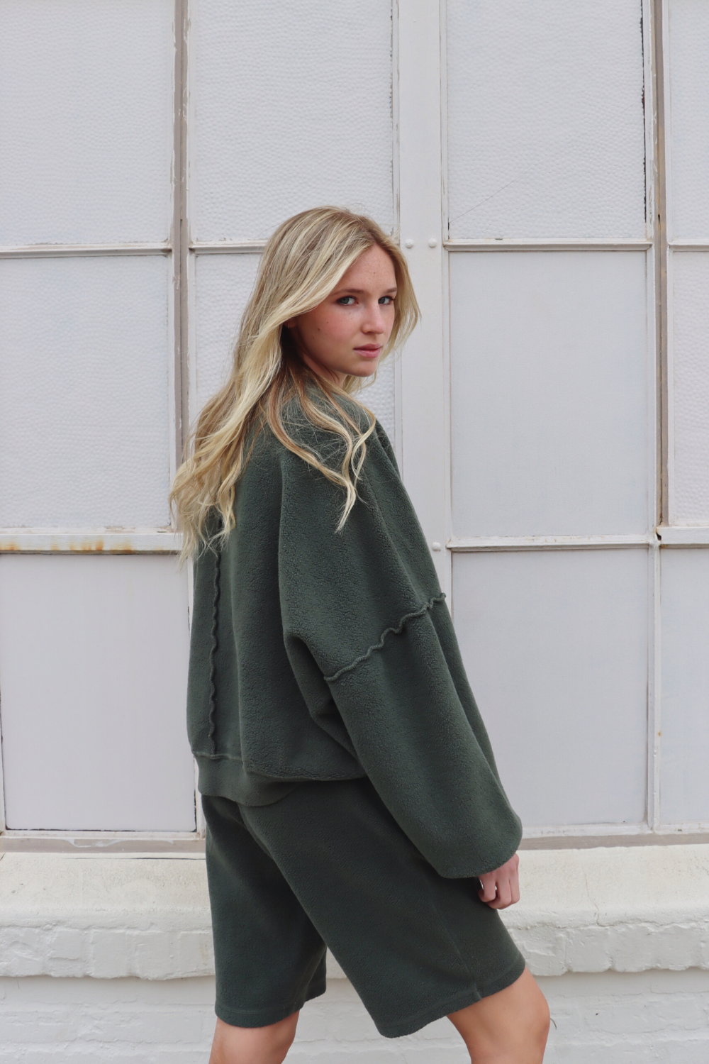 Sophie Shorts in Olive color with pockets and drawstring waist, displayed on a model.