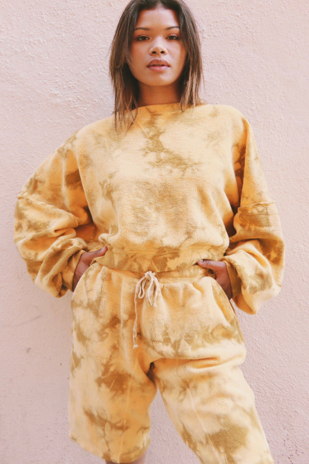 Sophie Tie-Dye Set featuring an oversized cropped sweatshirt and relaxed fit shorts in a vibrant yellow tie-dye pattern.