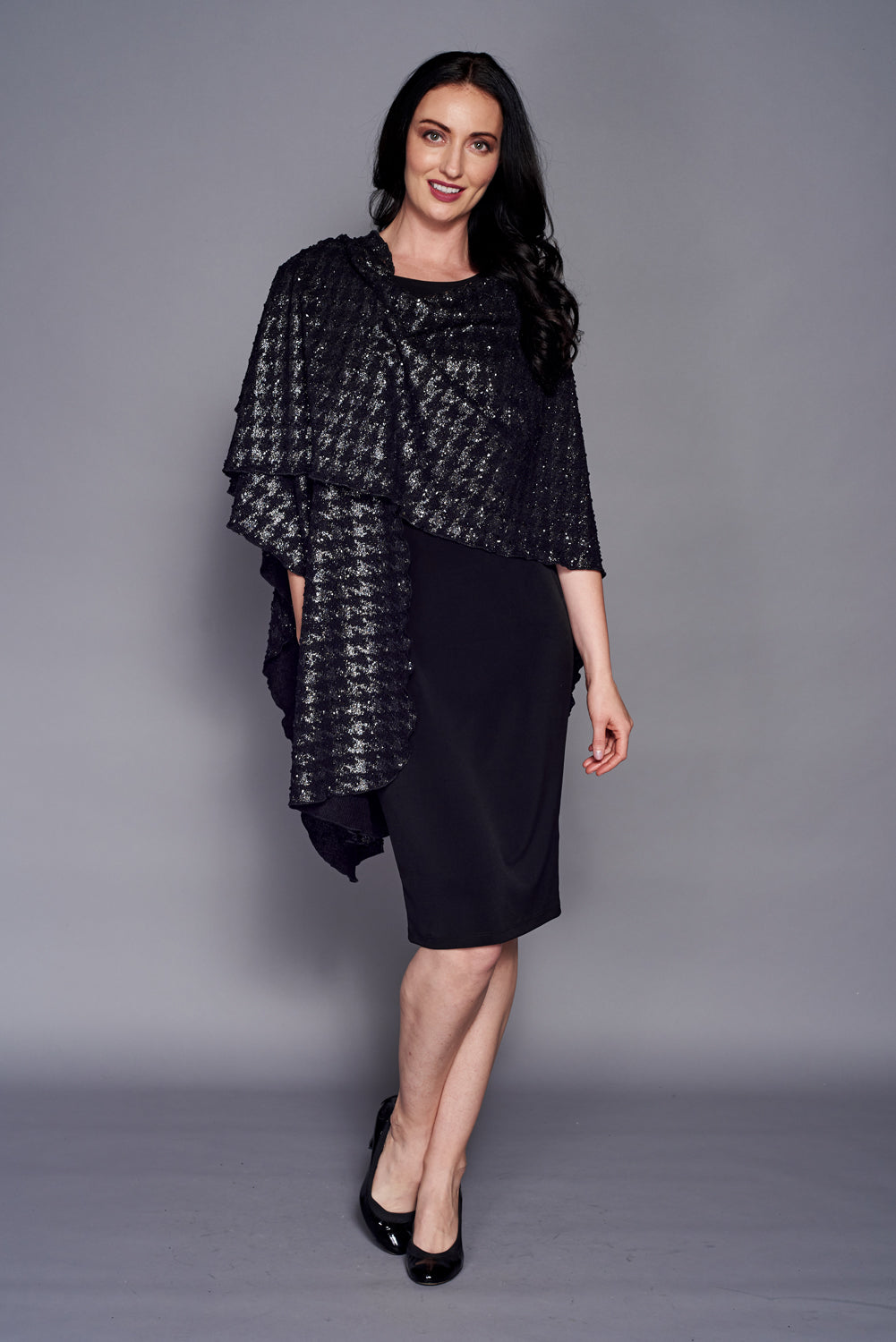 A stylish Sparkle Knit Shawl featuring a houndstooth pattern, perfect for winter evenings.