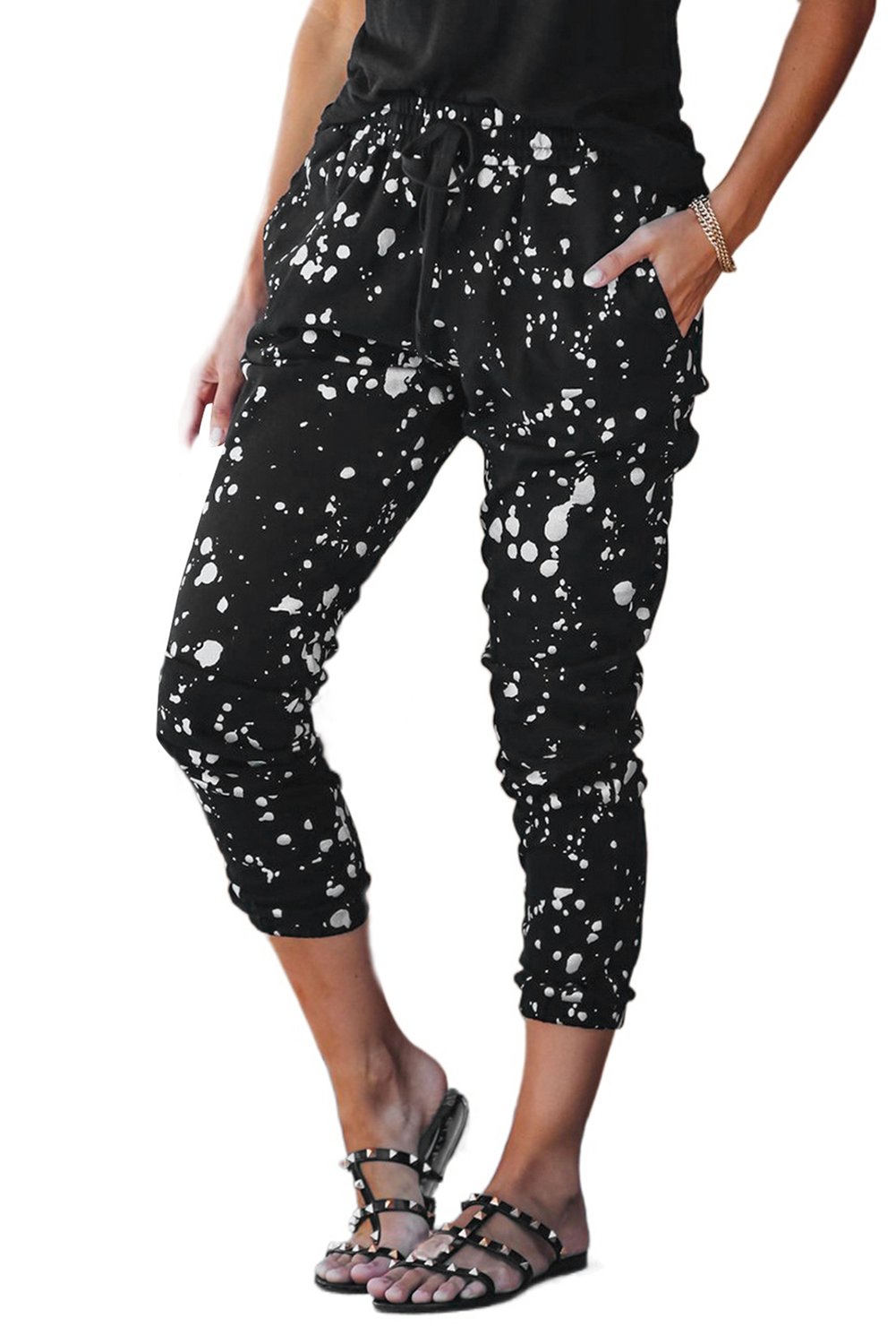 A pair of stylish Splatter Cotton Pocketed Joggers featuring a black base with metallic chrome splatter print, showcasing unfinished side pockets and a drawstring waist.