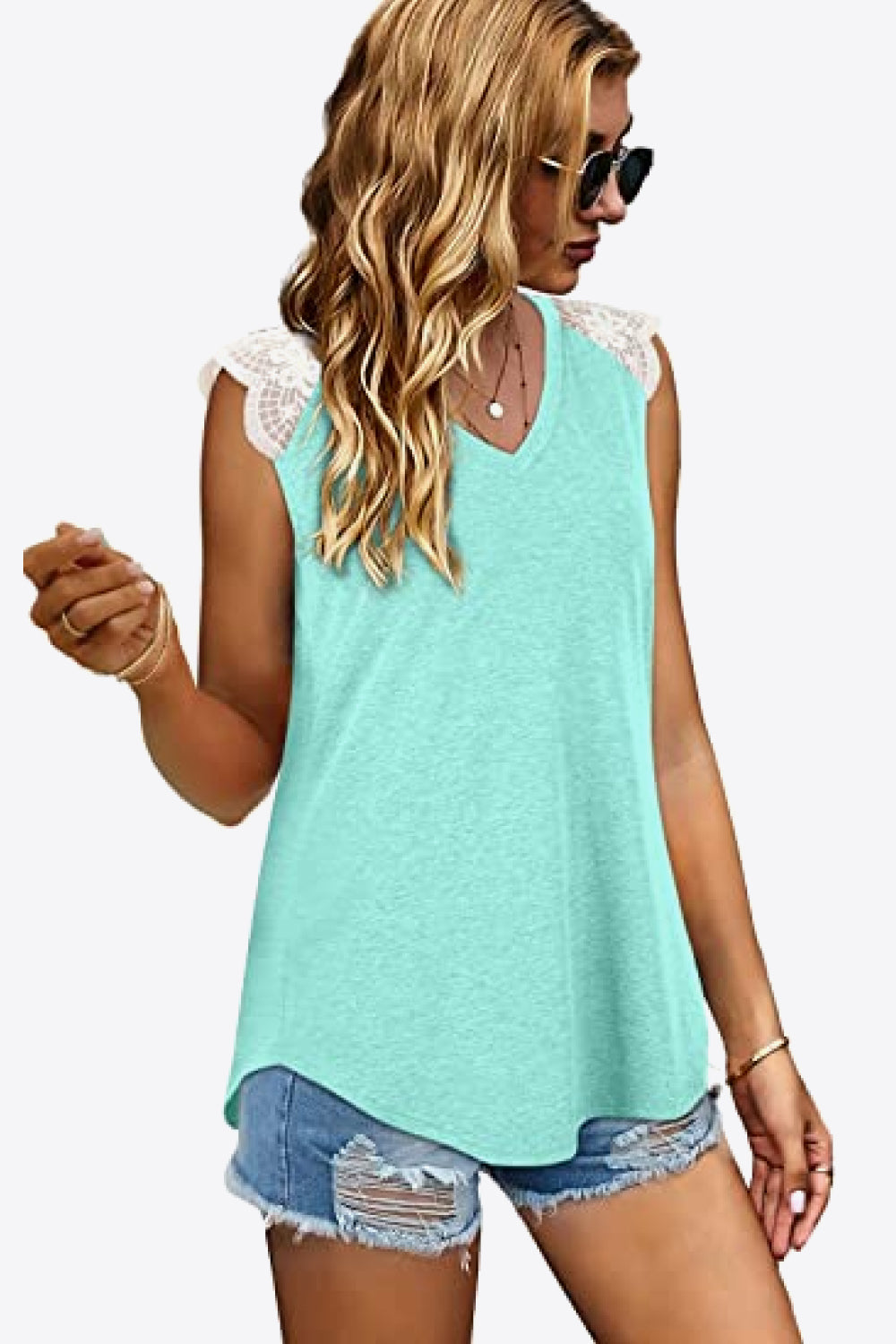 Spliced Lace Curved Hem Blouse featuring a V-neck and cap sleeves, showcasing a stylish design in a solid color.