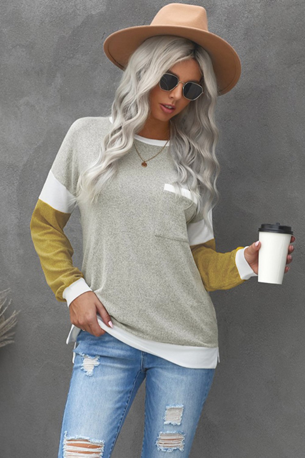 A stylish brown knit top featuring splicing sleeves, contrast neckline, and cuffs, perfect for casual wear.