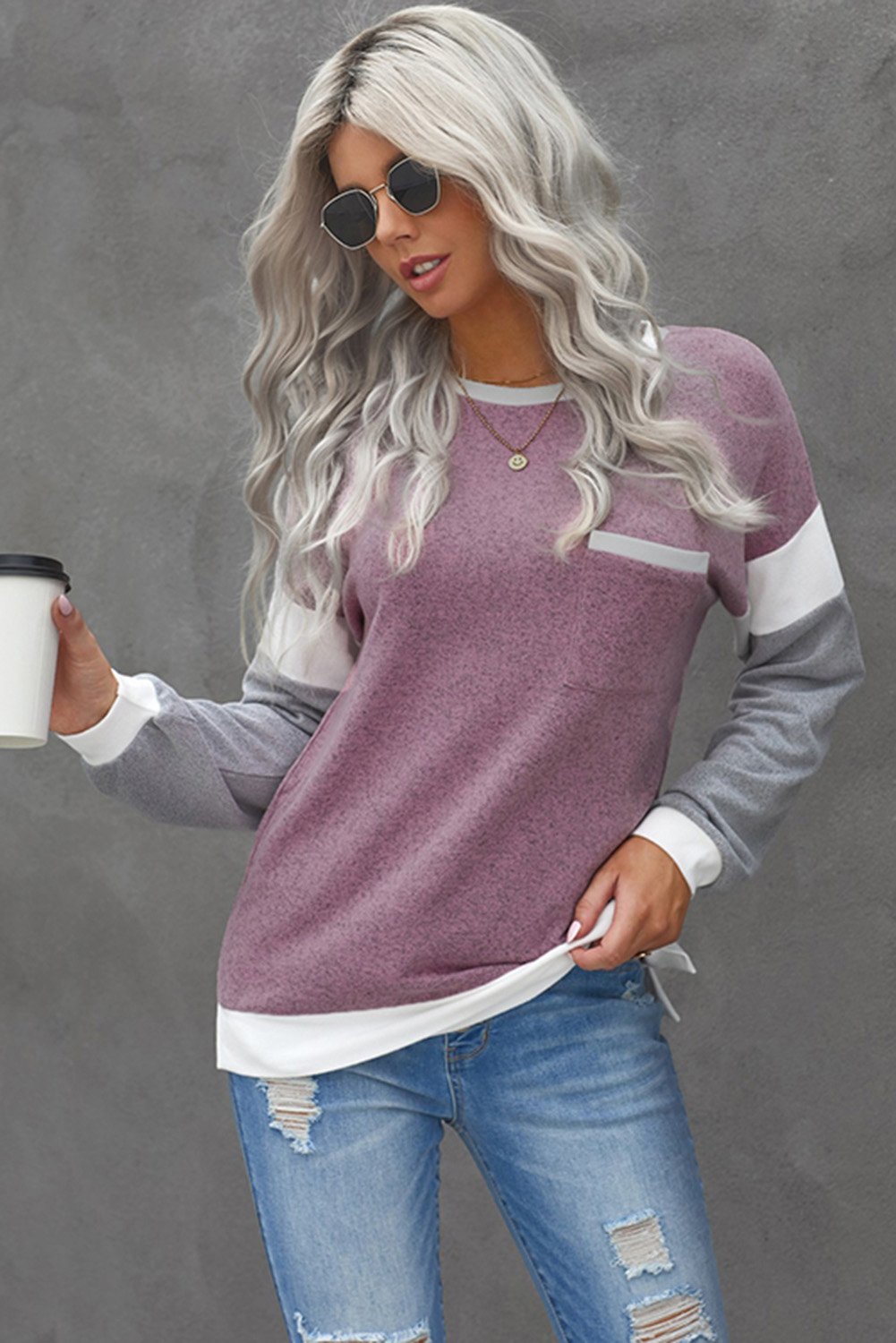 A stylish brown knit top featuring splicing sleeves, contrast neckline, and cuffs, perfect for casual wear.