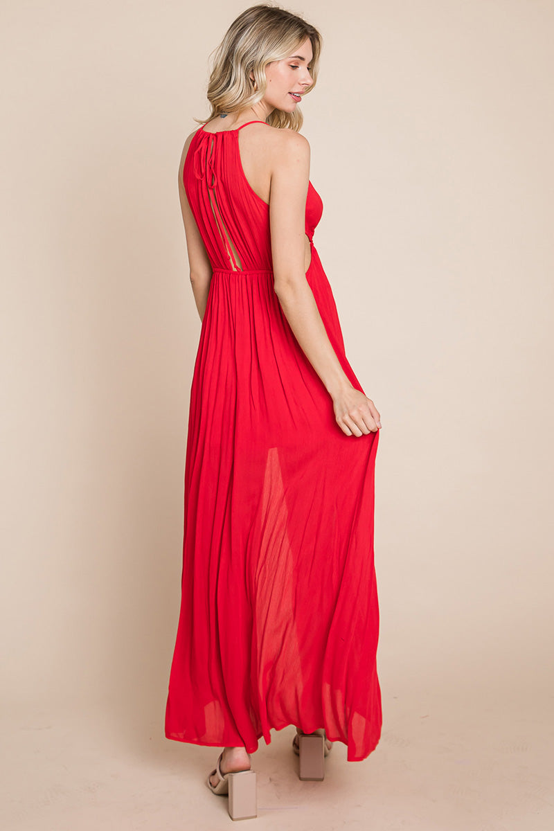 A stylish woman wearing a Split Front Cut Out Halter Maxi Dress, showcasing the elegant design and flattering silhouette.