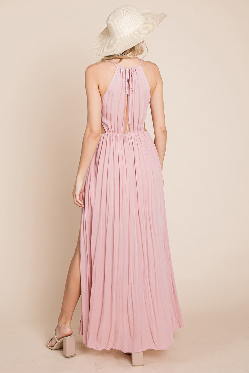 A stylish woman wearing a Split Front Cut Out Halter Maxi Dress, showcasing the elegant design and flattering silhouette.