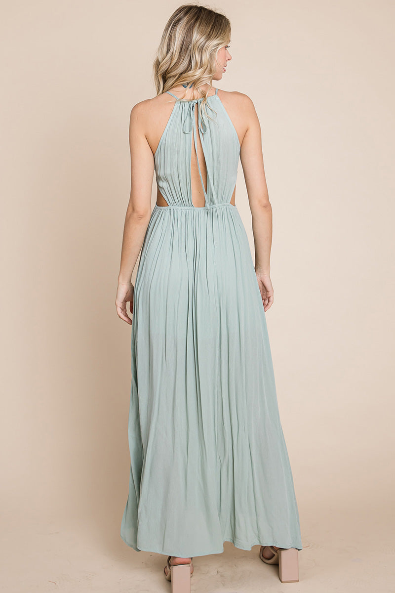 A stylish woman wearing a Split Front Cut Out Halter Maxi Dress, showcasing the elegant design and flattering silhouette.