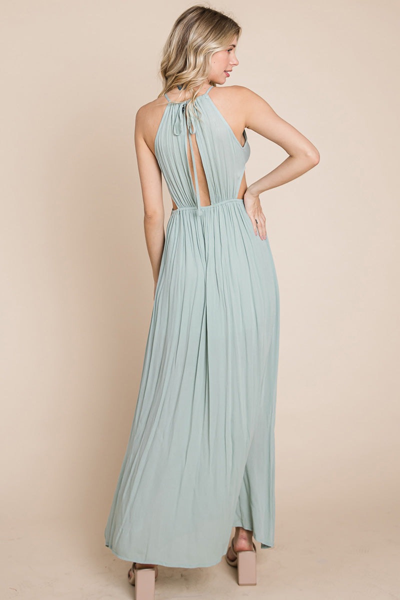 A stylish woman wearing a Split Front Cut Out Halter Maxi Dress, showcasing the elegant design and flattering silhouette.