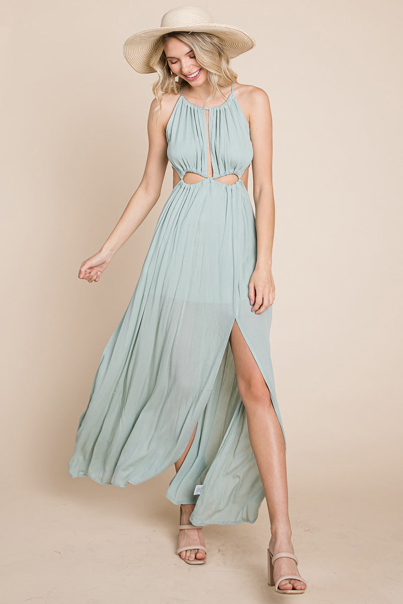 A stylish woman wearing a Split Front Cut Out Halter Maxi Dress, showcasing the elegant design and flattering silhouette.