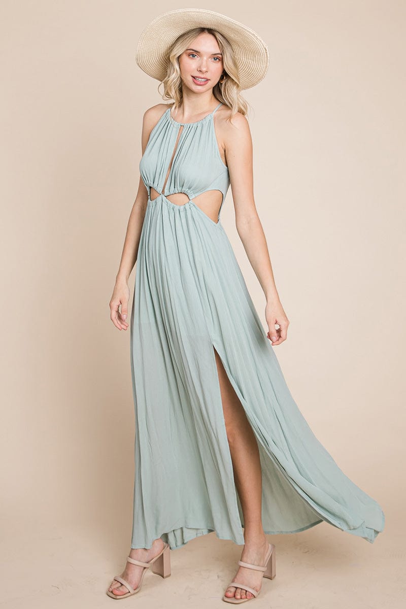 A stylish woman wearing a Split Front Cut Out Halter Maxi Dress, showcasing the elegant design and flattering silhouette.