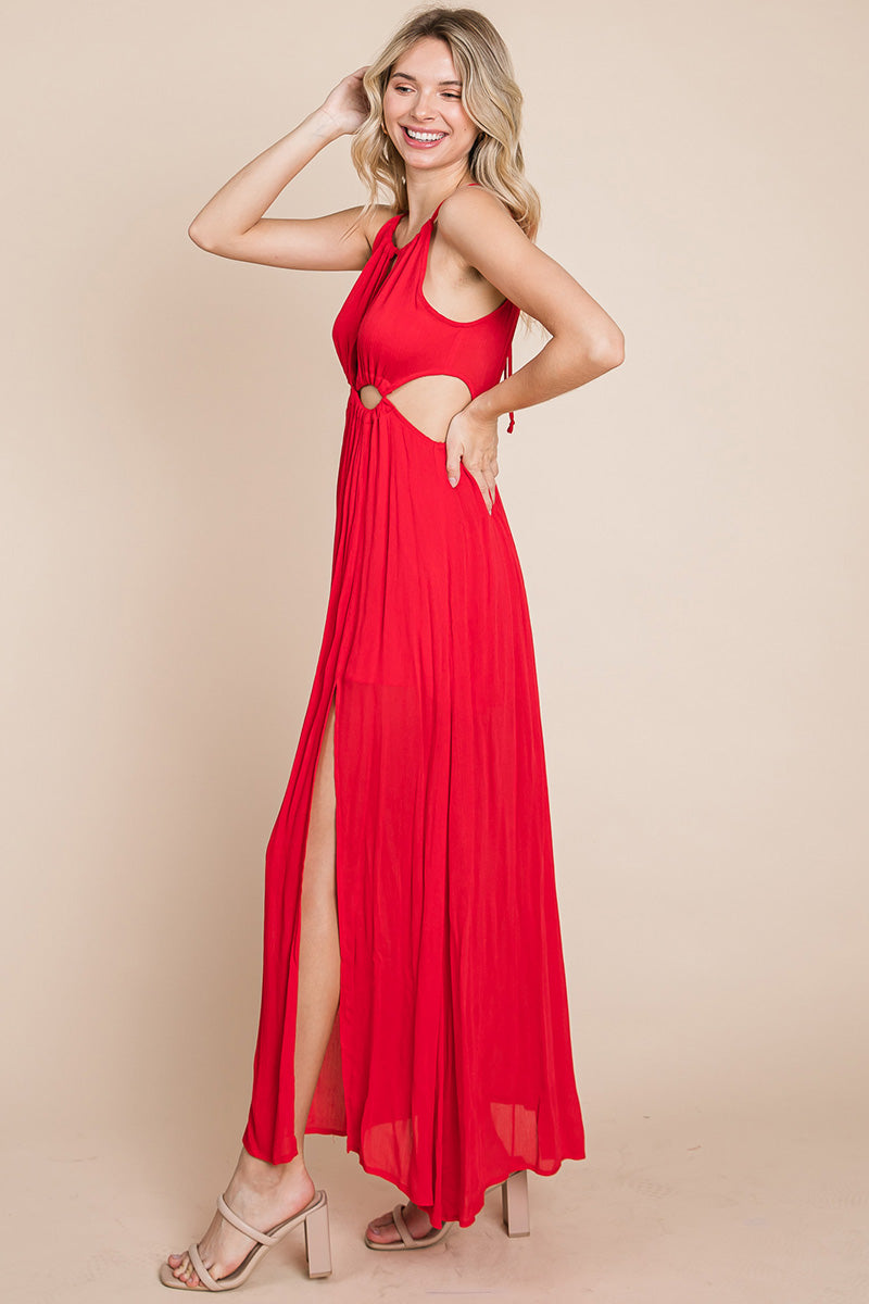 A stylish woman wearing a Split Front Cut Out Halter Maxi Dress, showcasing the elegant design and flattering silhouette.