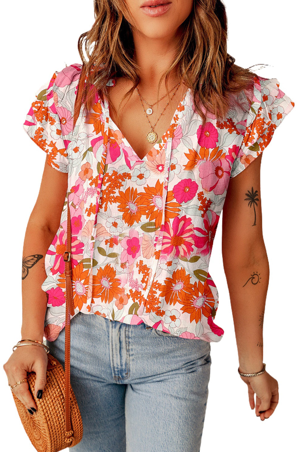 A stylish Split Ruffle Sleeve Floral Blouse featuring a split v-neck and feminine ruffle sleeves in a vibrant floral pattern.