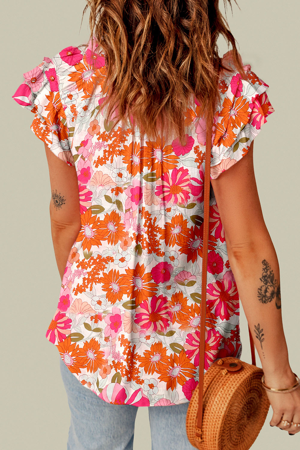 A stylish Split Ruffle Sleeve Floral Blouse featuring a split v-neck and feminine ruffle sleeves in a vibrant floral pattern.