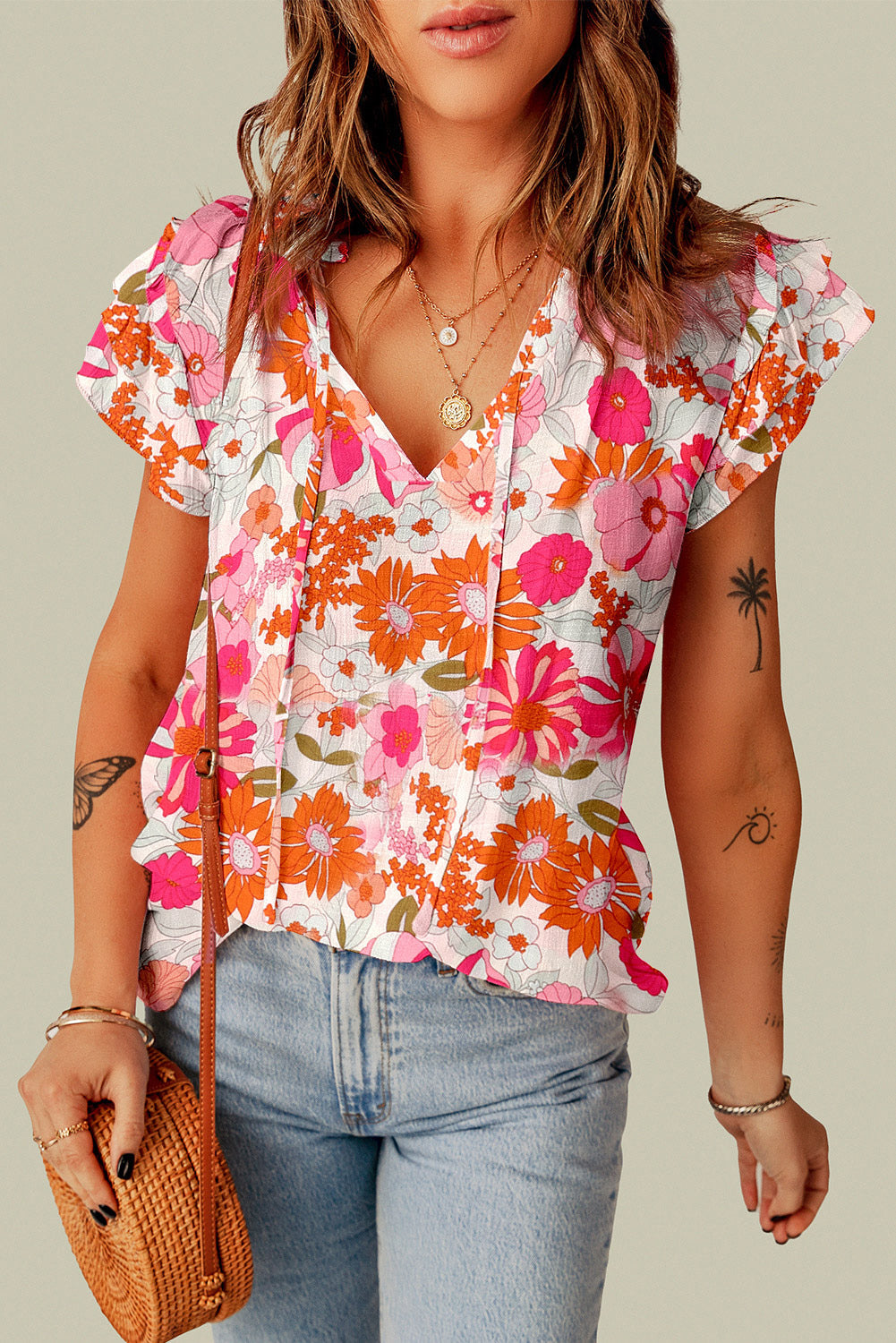 A stylish Split Ruffle Sleeve Floral Blouse featuring a split v-neck and feminine ruffle sleeves in a vibrant floral pattern.