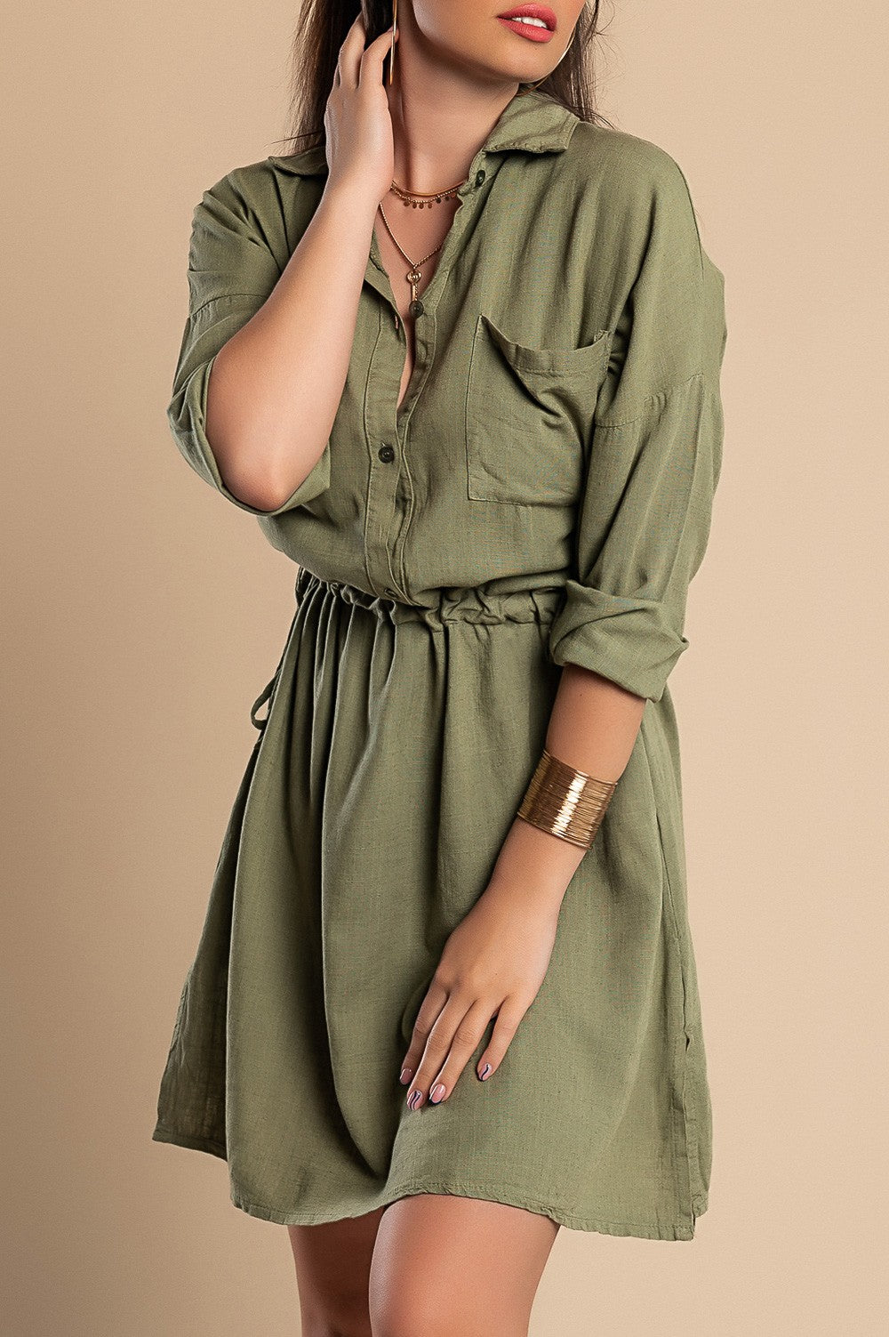 Olive green SPORT MINI DRESS featuring a classic collar, long sleeves, decorative front pocket, and side slits for a stylish look.