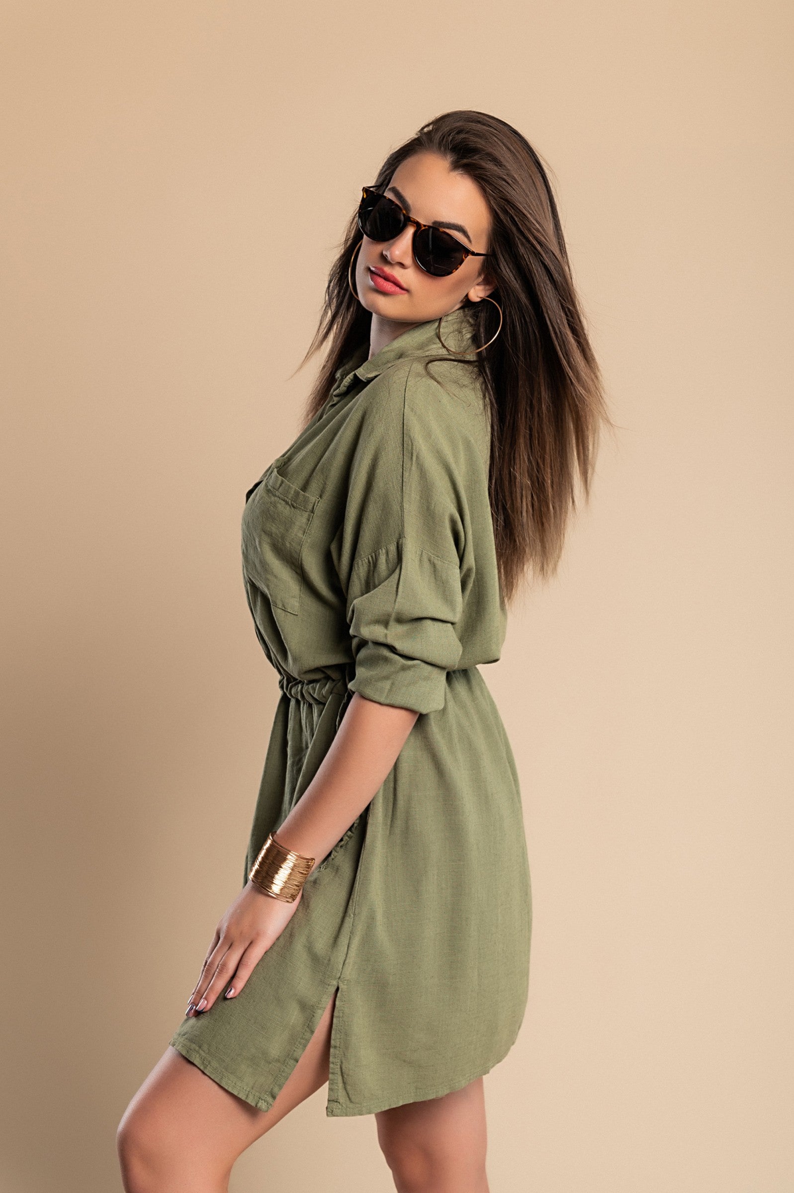 Olive green SPORT MINI DRESS featuring a classic collar, long sleeves, decorative front pocket, and side slits for a stylish look.