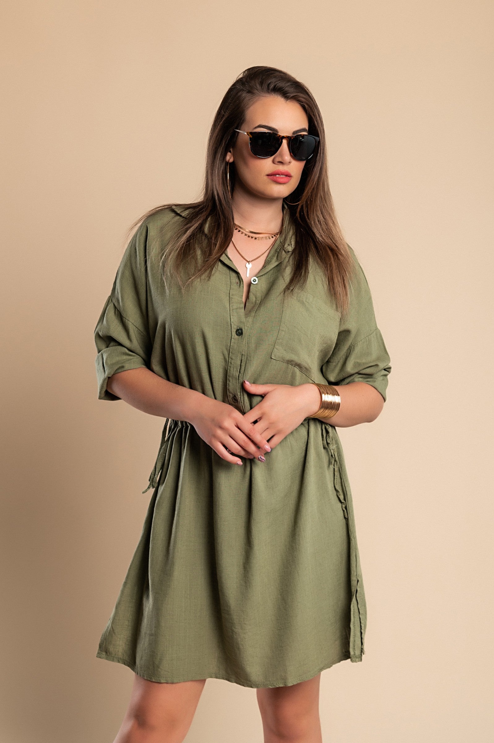 Olive green SPORT MINI DRESS featuring a classic collar, long sleeves, decorative front pocket, and side slits for a stylish look.