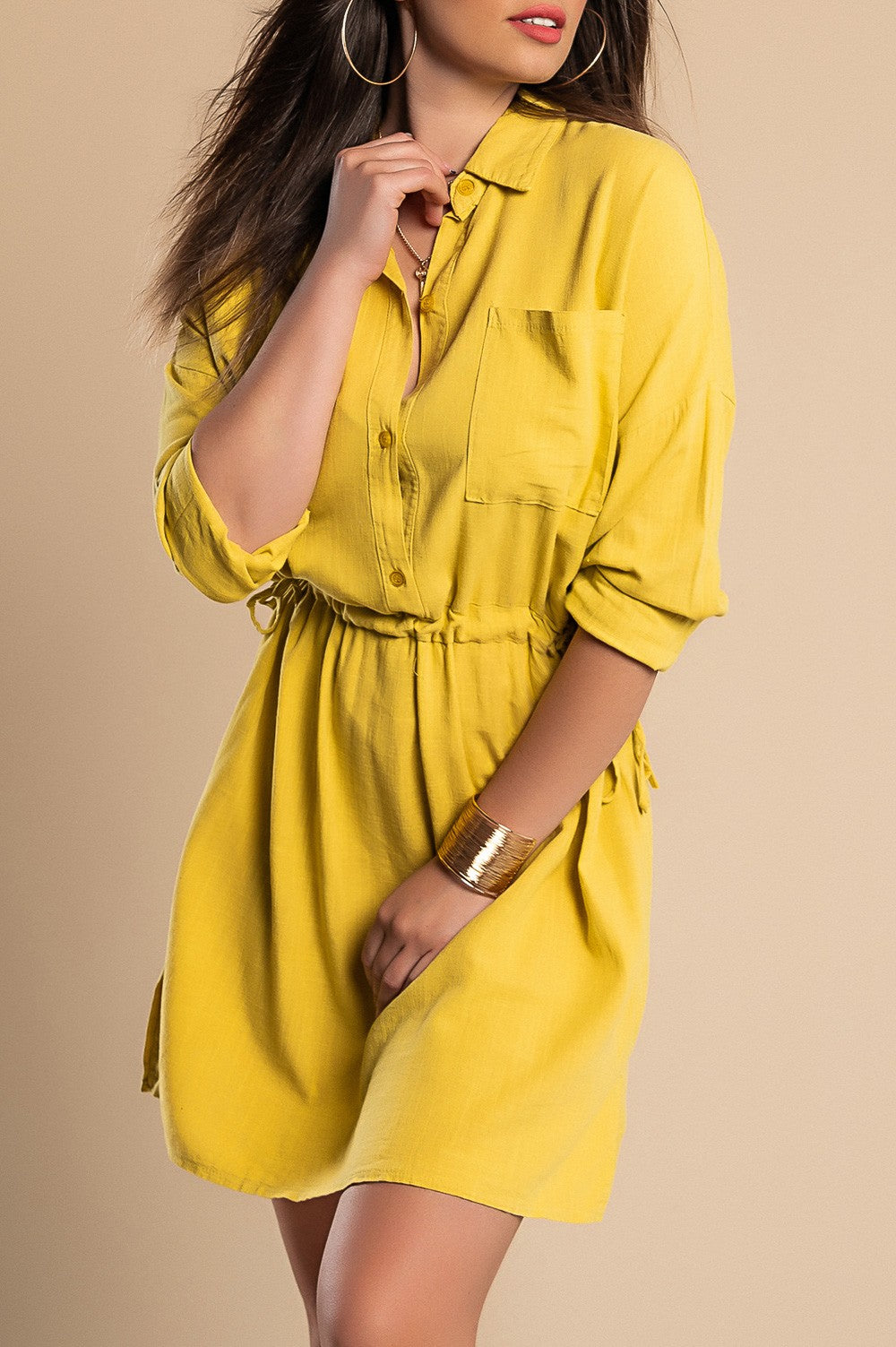 A vibrant yellow SPORT MINI DRESS featuring a classic collar, long sleeves, decorative front pocket, and mid-thigh skirt with side slits.