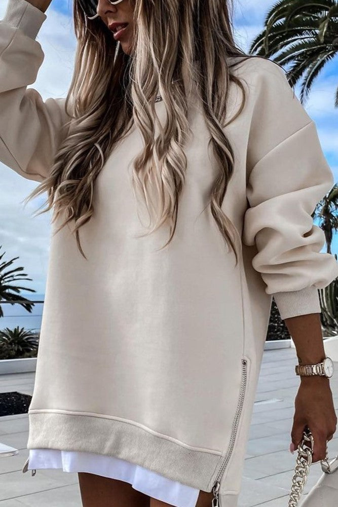 Cream sports mini dress featuring a round neck, long sleeves, and side zip, designed for comfort and style.