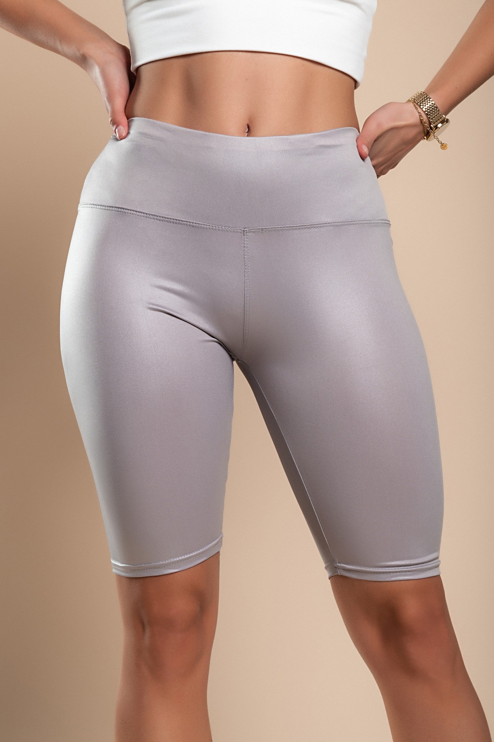 Gray sports shorts made of soft, elastic fabric with a high waist and mid-thigh length, perfect for workouts and casual wear.