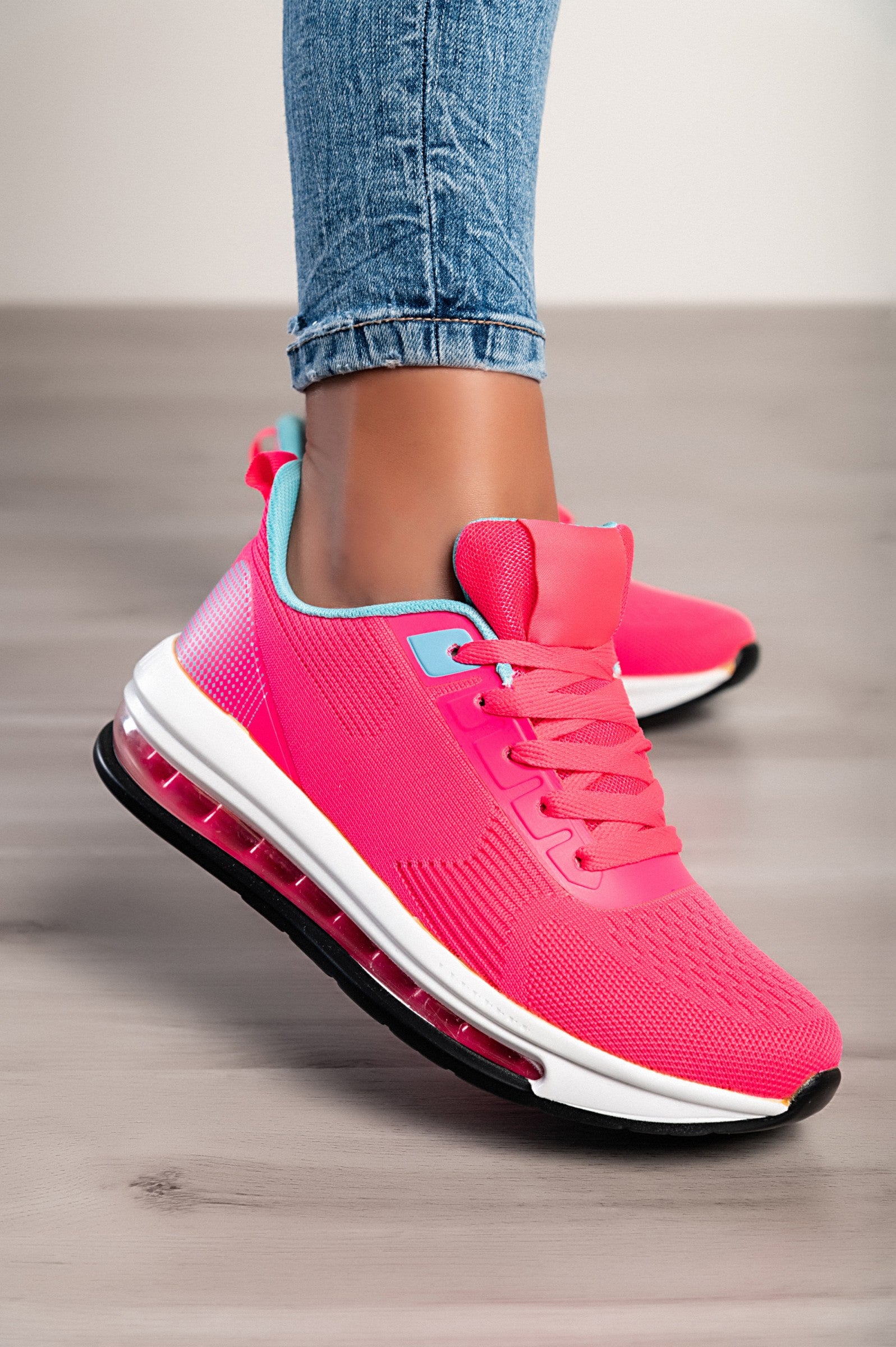 A pair of stylish sports sneakers featuring a vibrant red and blue two-tone design, with a round toe and lace-up closure.