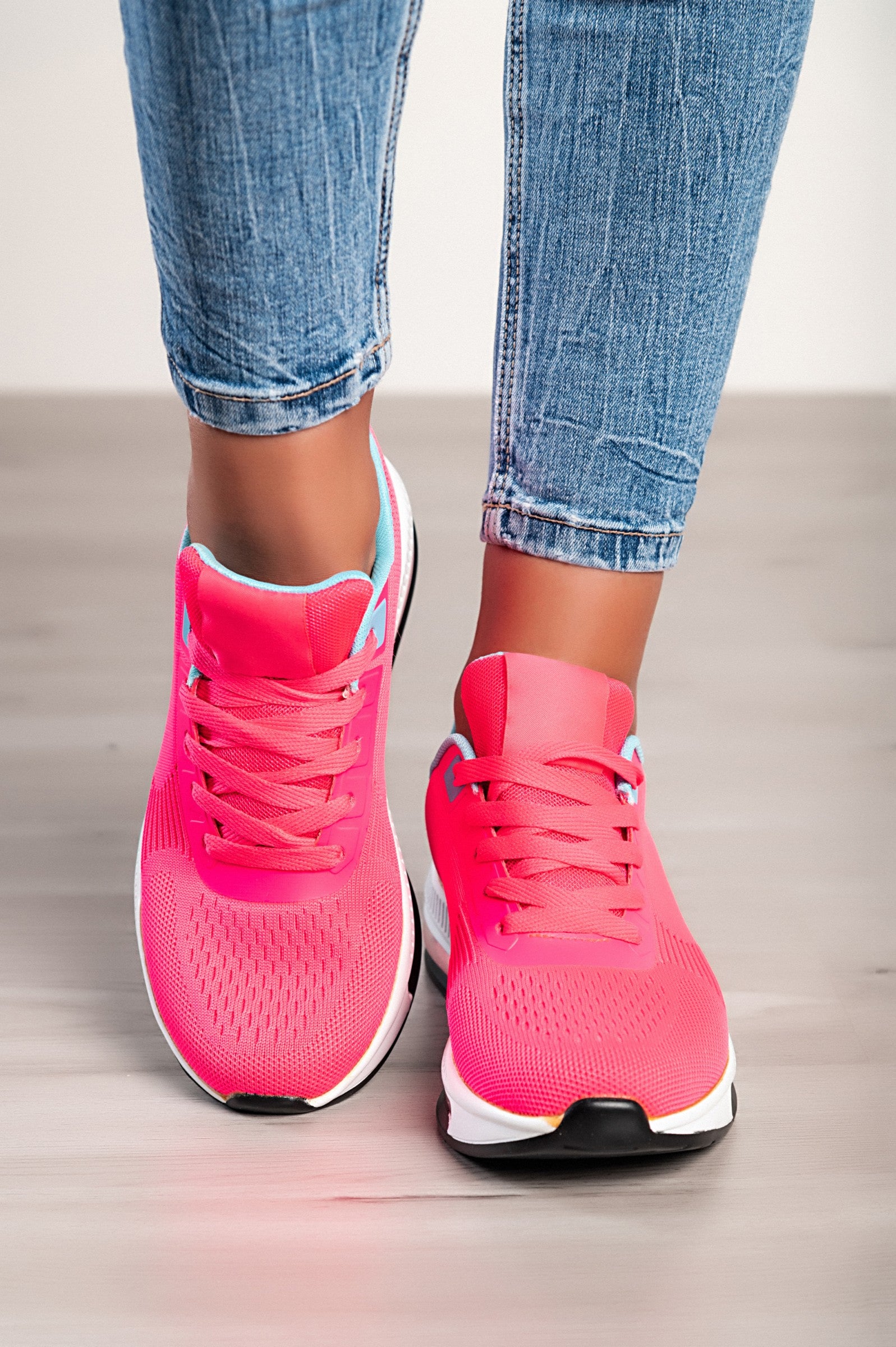 A pair of stylish sports sneakers featuring a vibrant red and blue two-tone design, with a round toe and lace-up closure.