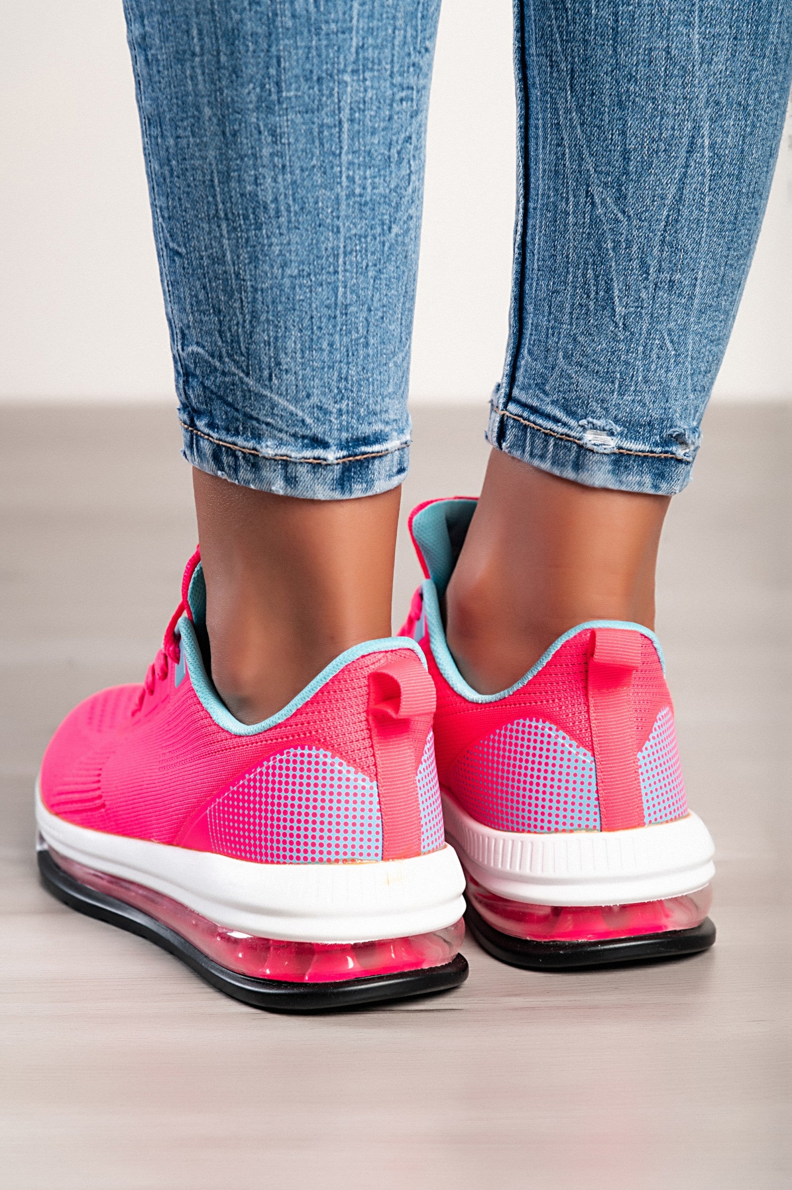 A pair of stylish sports sneakers featuring a vibrant red and blue two-tone design, with a round toe and lace-up closure.