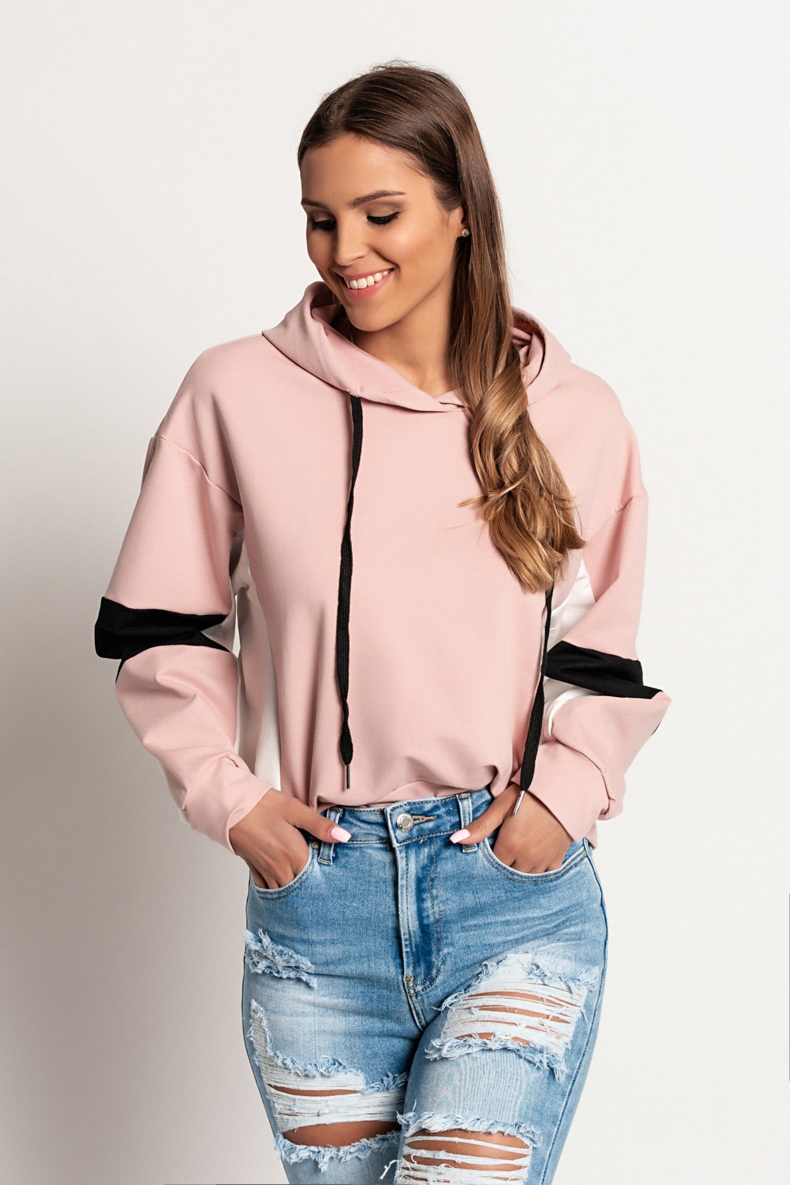 Light pink Jappola sports sweatshirt with a drawstring hood and long sleeves, showcasing a comfortable and stylish design.