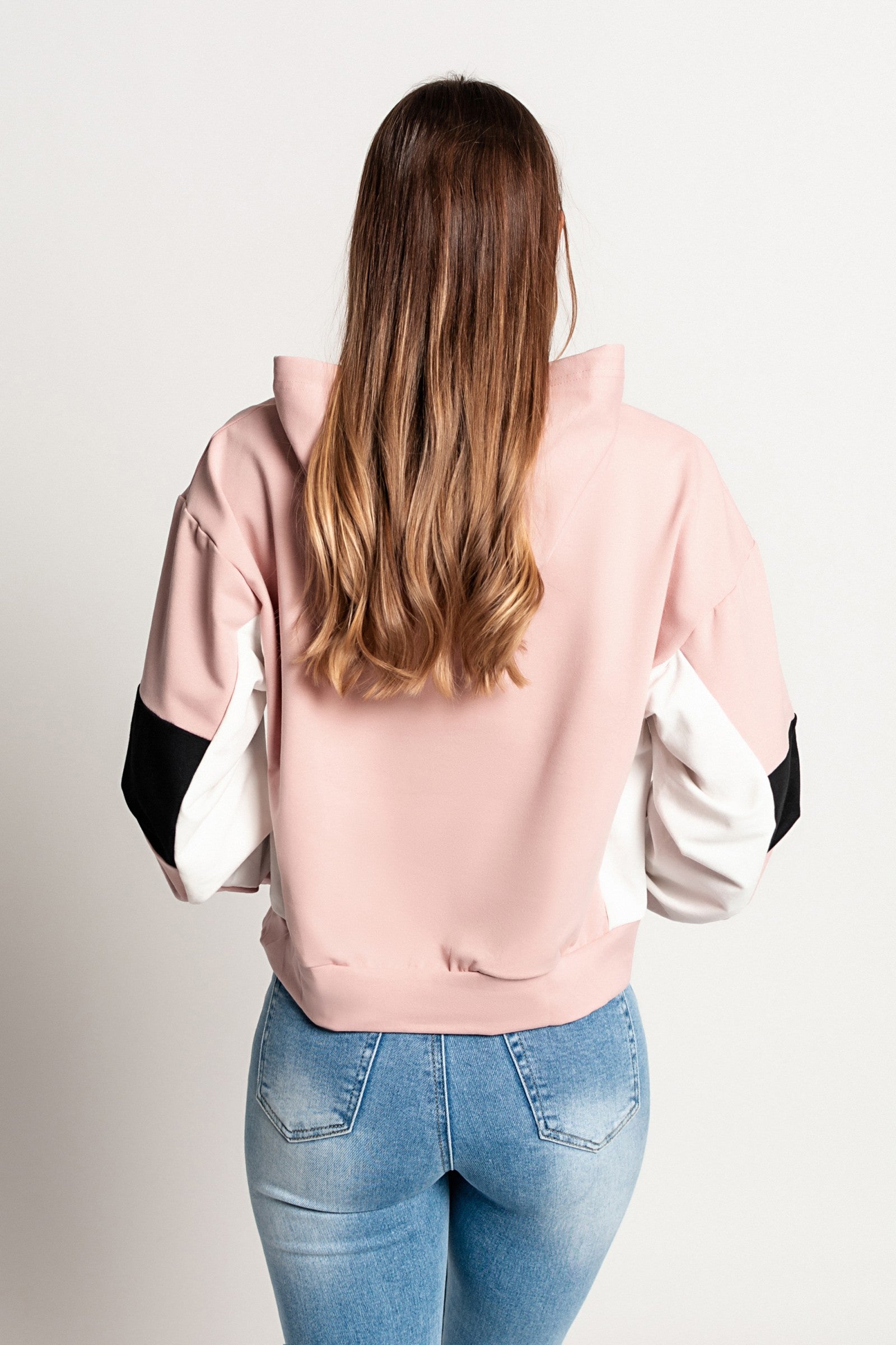 Light pink Jappola sports sweatshirt with a drawstring hood and long sleeves, showcasing a comfortable and stylish design.