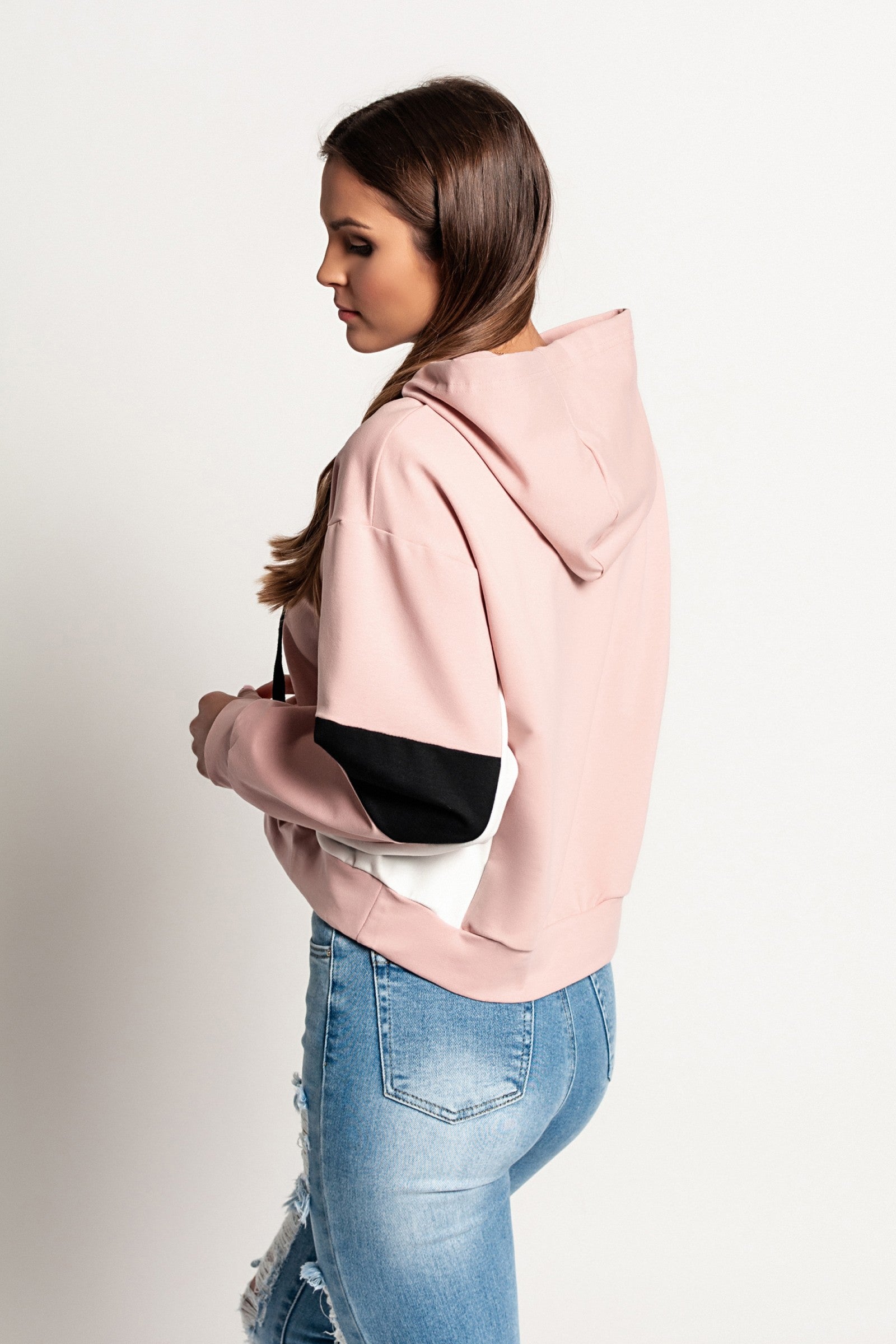 Light pink Jappola sports sweatshirt with a drawstring hood and long sleeves, showcasing a comfortable and stylish design.