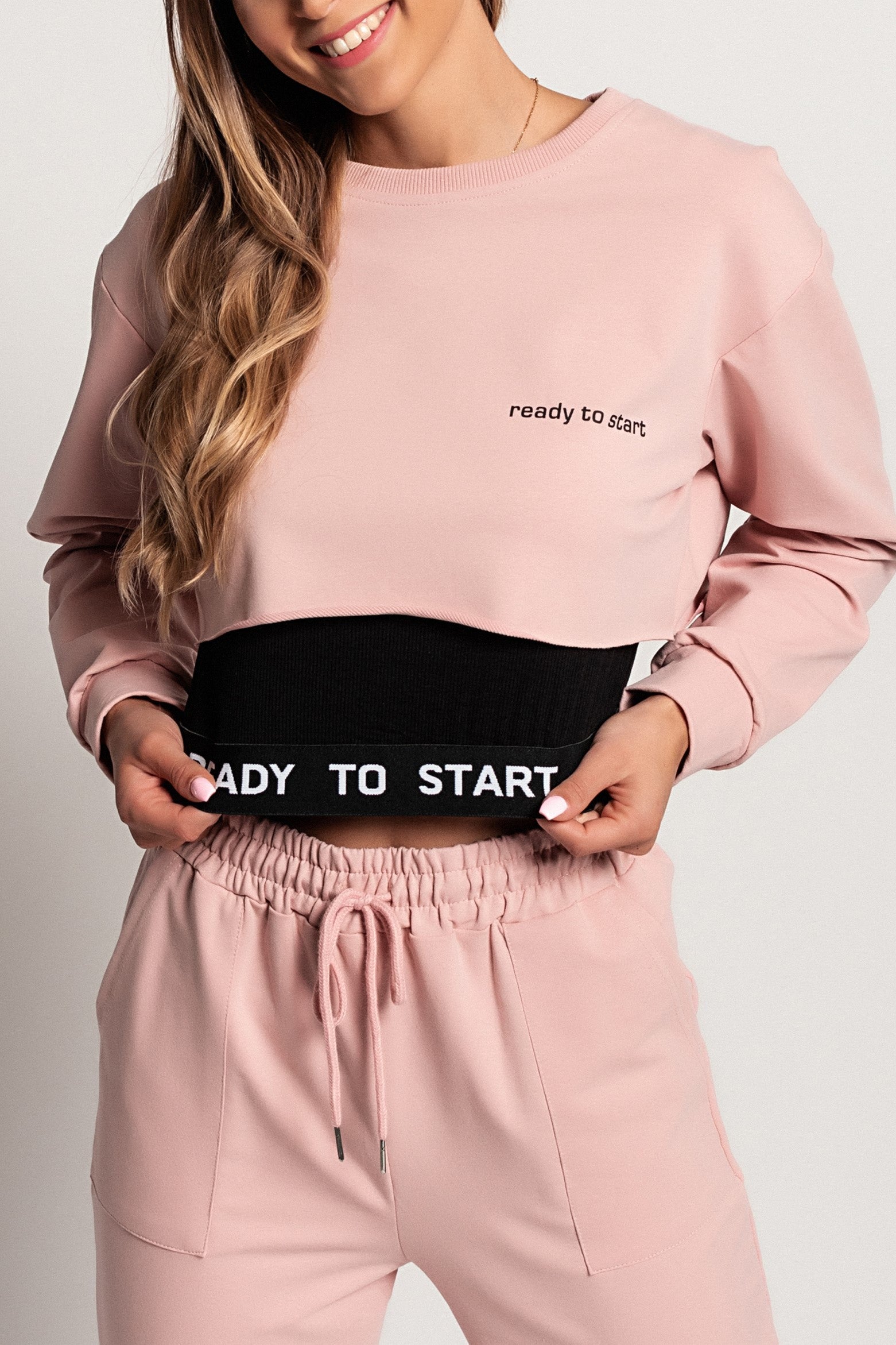 Light pink sports top and t-shirt set featuring a loose-fitting long sleeve t-shirt with lettering and a sleeveless ribbed crop top.