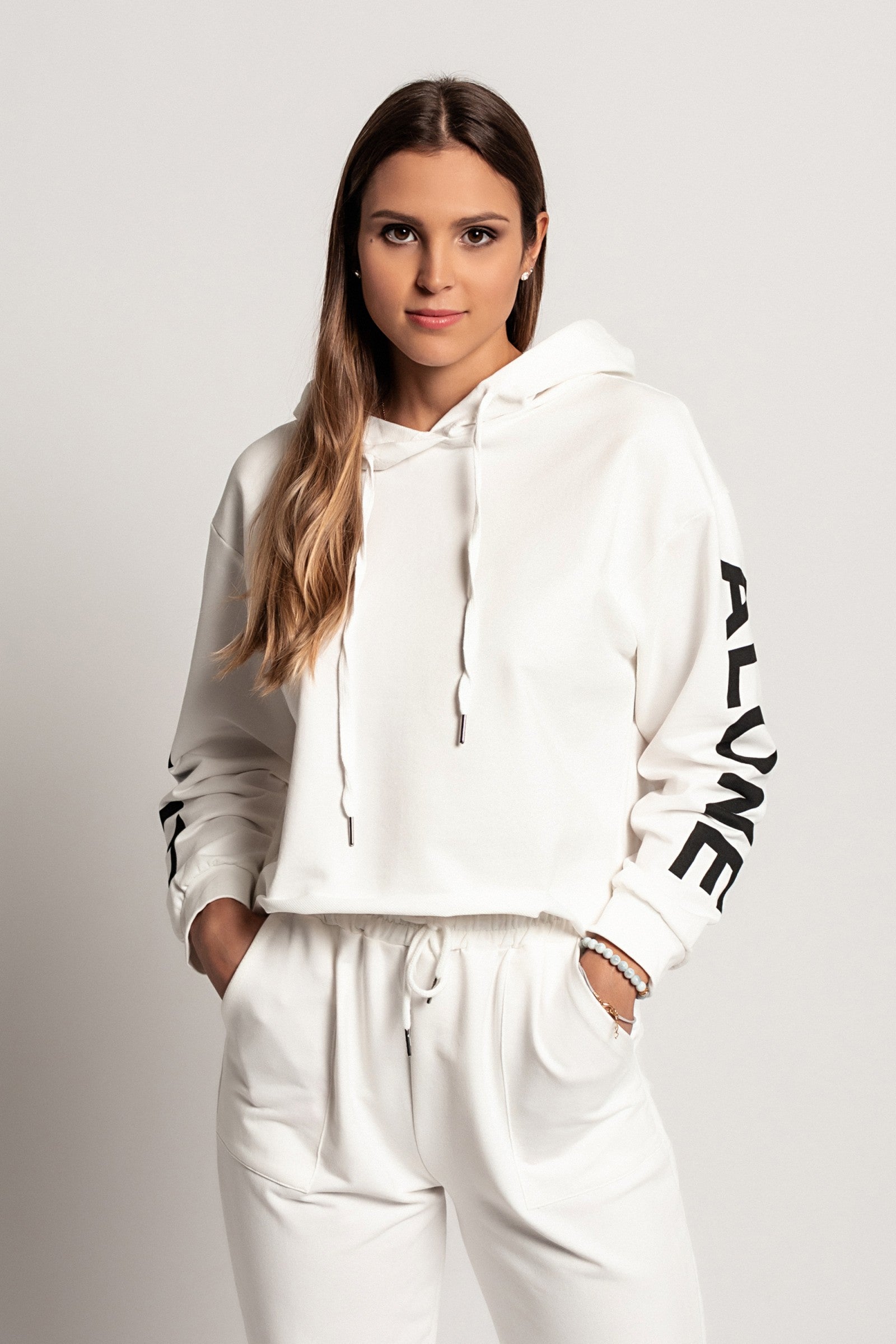 Sporty white hoodie with printed long sleeves and drawstring hood, showcasing a comfortable and stylish design.