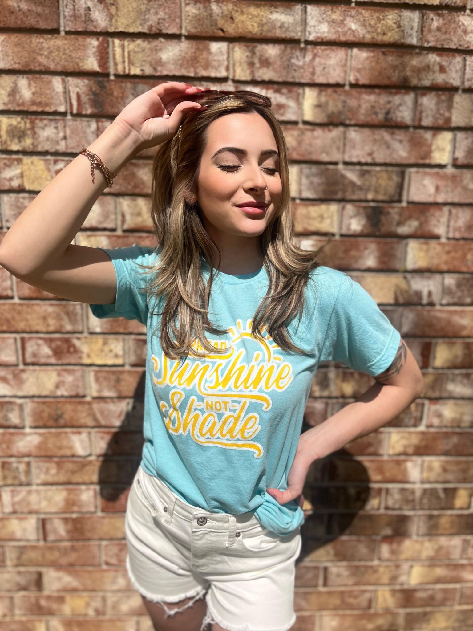 A vibrant unisex t-shirt with the phrase 'Spread Sunshine Not Shade' printed in colorful letters, showcasing a soft fabric and true-to-size fit.