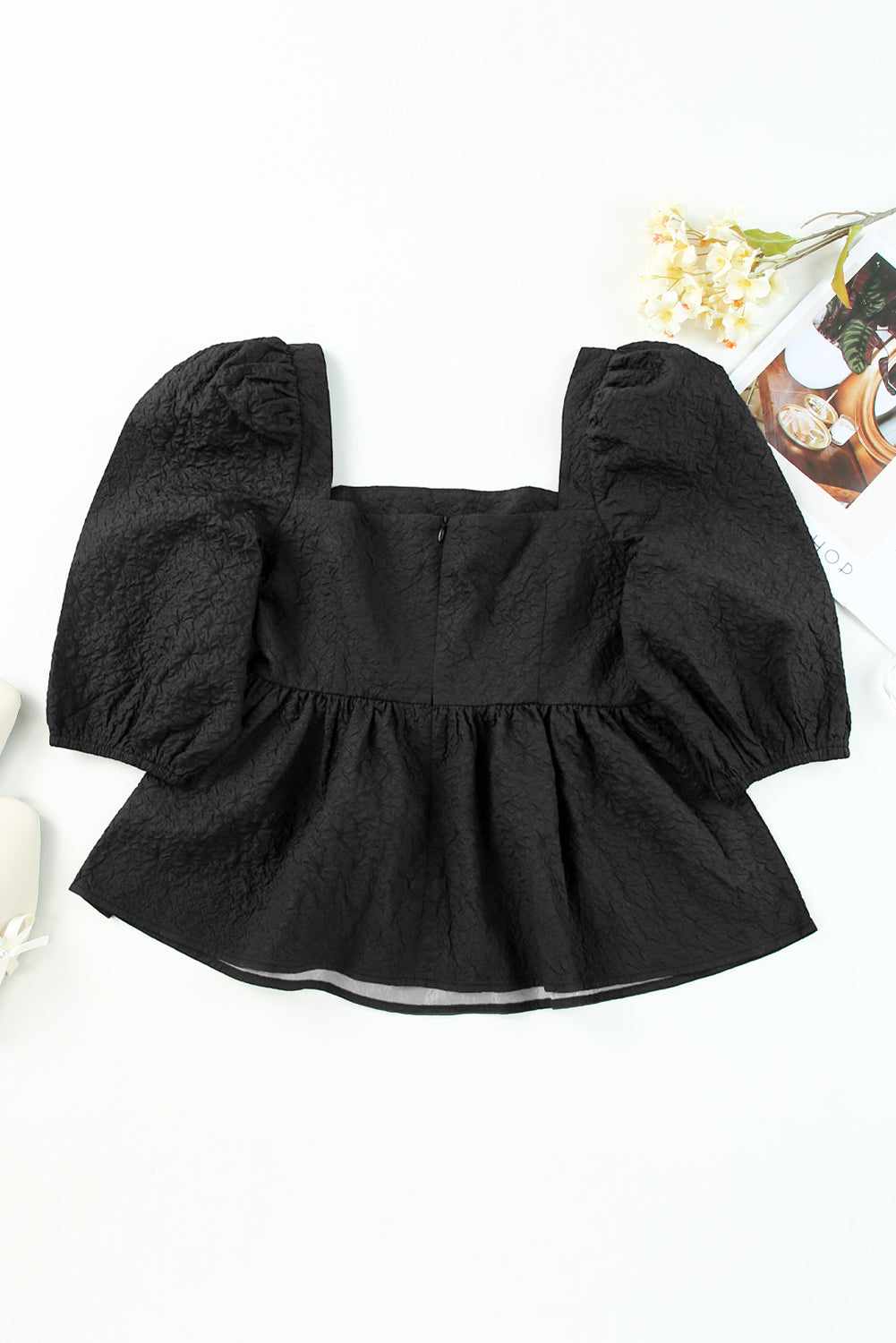 A stylish square neck blouse with puff sleeves, featuring a peplum design, perfect for casual and formal occasions.