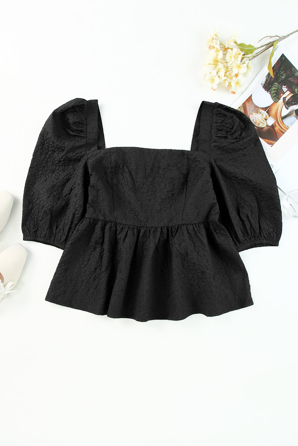 A stylish square neck blouse with puff sleeves, featuring a peplum design, perfect for casual and formal occasions.