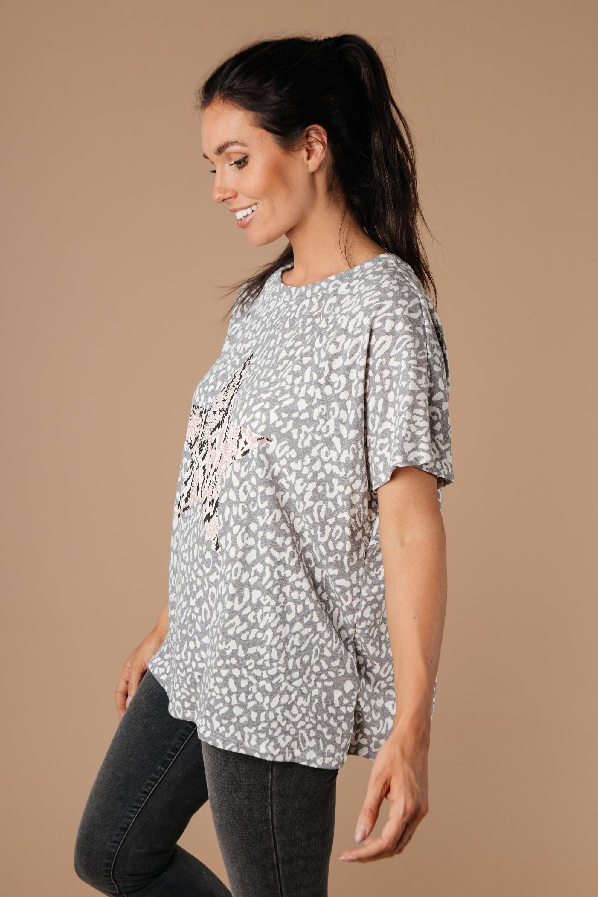 Star Of The Animal Show Top in Charcoal featuring leopard and snake prints, round neckline, and short sleeves.