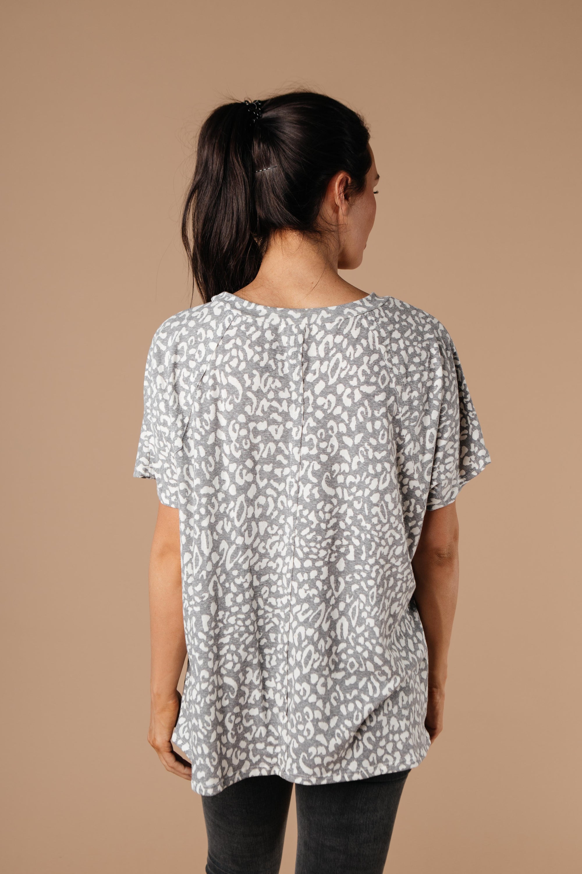 Star Of The Animal Show Top in Charcoal featuring leopard and snake prints, round neckline, and short sleeves.