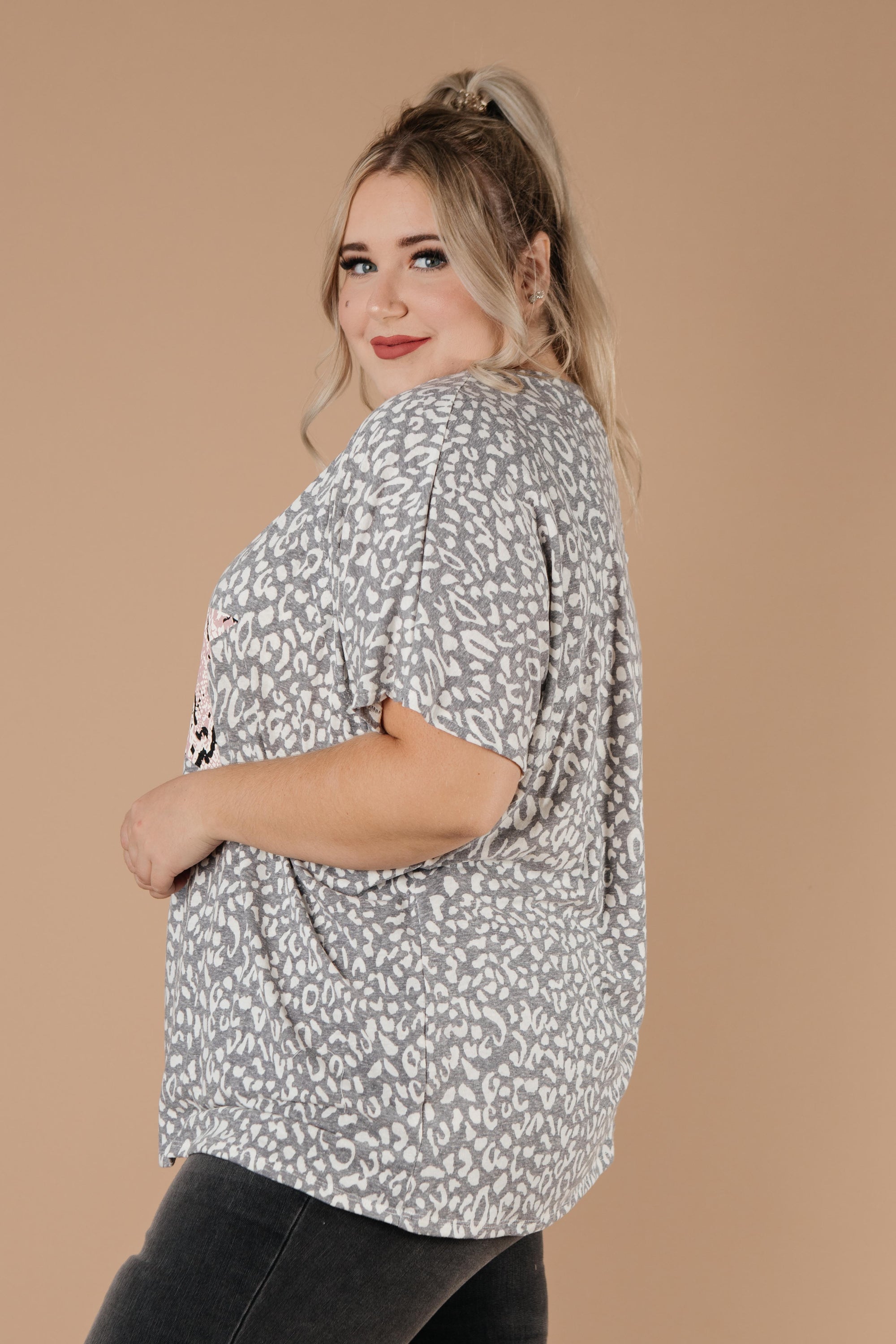 Star Of The Animal Show Top in Charcoal featuring leopard and snake prints, round neckline, and short sleeves.