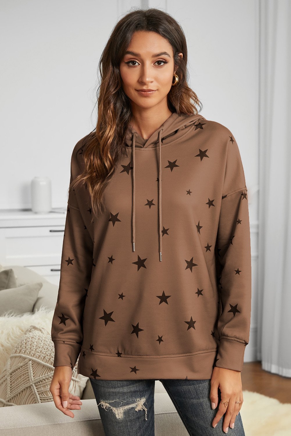 A stylish star print hoodie featuring side slits, adjustable drawstring, and a relaxed fit, perfect for casual wear.