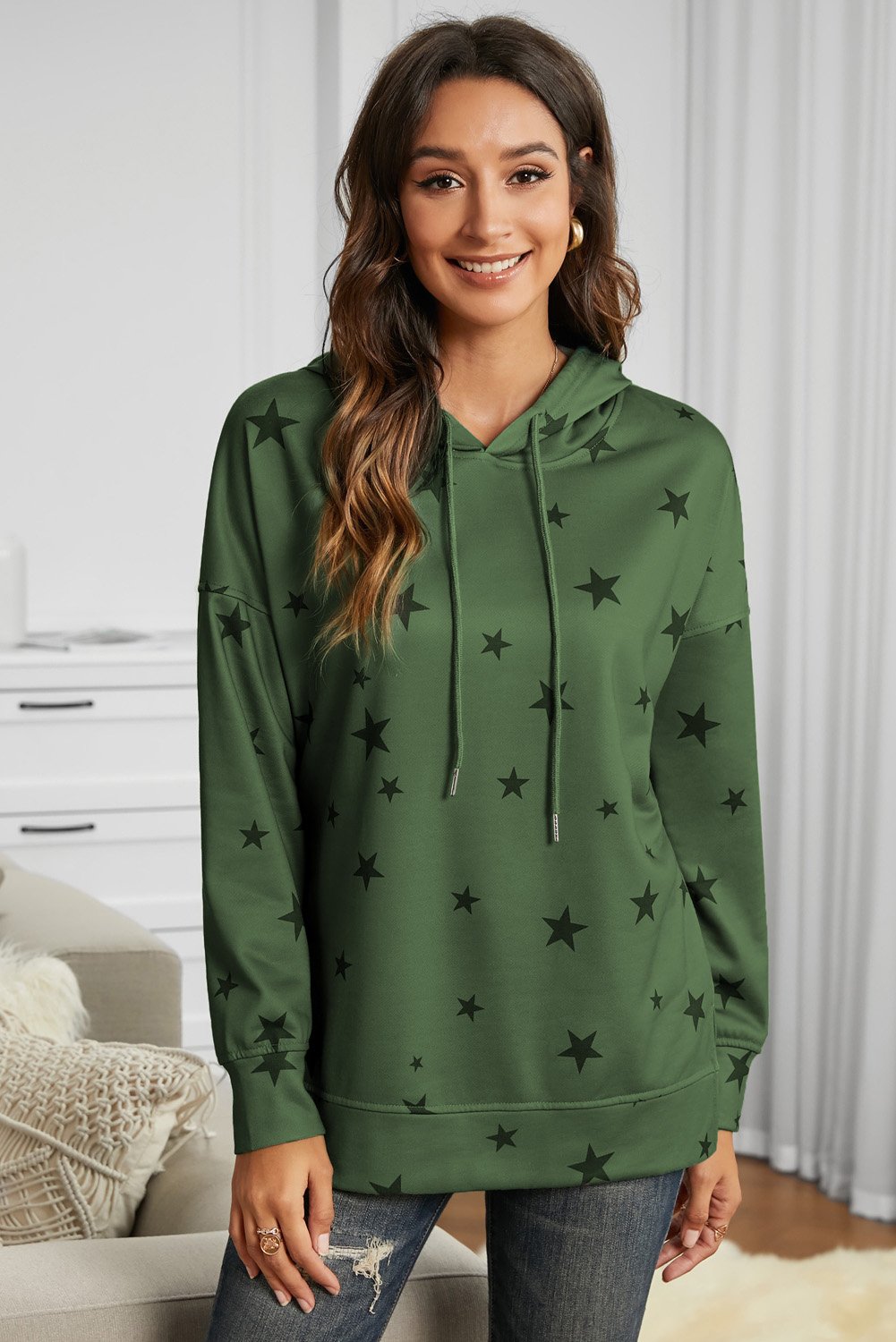 A stylish star print hoodie featuring side slits, adjustable drawstring, and a relaxed fit, perfect for casual wear.